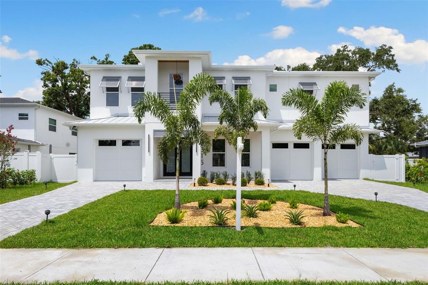 Nestled on a dead-end street in the heart of South Tampa, this exquisite luxury residence is a masterpiece of modern design. Spanning over 5,000 square feet, this home offers 5 generously sized bedrooms and 4.5 beautiful bathrooms. Upon entering, you are welcomed with engineered hardwood flooring that flows seamlessly throughout the home. Just off the entryway, you'll find a dedicated office, as well as a formal dining room, perfect for hosting elegant dinner parties and special occasions. Coming in from the right-side garage is a mudroom complete with a convenient washer and dryer and ample storage space. The home features a split 3-car garage, each with an EV charger, offering both functionality and convenience. The heart of the home boasts a gourmet kitchen with Monogram appliances, abundant storage, a walk-in butler’s pantry, and an open concept that flows effortlessly into the additional dining and living area. The main floor includes a guest bedroom with a full bathroom that also serves as a convenient pool bath. Large hurricane-rated sliding glass doors open to your private outdoor oasis, complete with a full outdoor kitchen, covered lanai, and pool and spa. A durable metal roof and hurricane-rated windows provide peace of mind, while a tankless hot water heater ensures efficiency. Upstairs welcomes you with a media room and a full laundry room, including a second washer and dryer. Two additional bedrooms share a thoughtfully designed Jack & Jill bathroom. Each space is enhanced with premium Delta hardware in the bathrooms and large windows that fill the rooms with natural light. The luxurious primary suite is a true retreat, featuring separate his-and-her walk-in closets and a spa-inspired bathroom with dual vanities, a soaking tub, private toilet, linen closet, and oversized shower. Situated in an X flood zone within the desirable Plant High School district, this property is close to Downtown Tampa, Hyde Park, Tampa International Airport, International Plaza, and so much more. Don't miss the opportunity to make this luxurious haven your own!