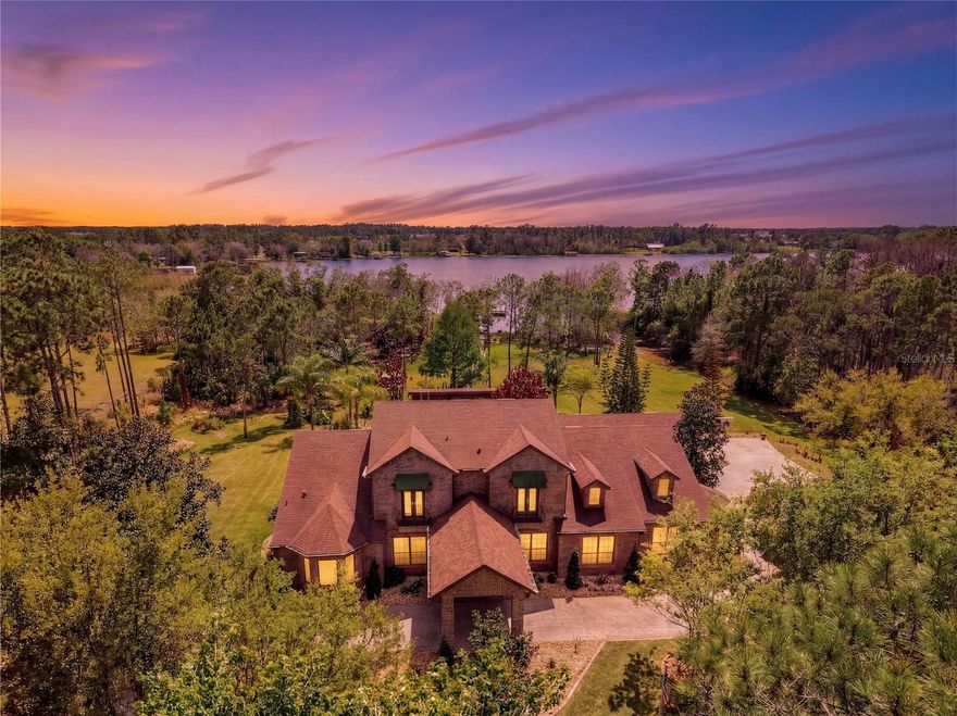 One or more photo(s) has been virtually staged. The Pinnacle of Lakefront Living......Designed to Entertain, Built to Endure, & Positioned to Inspire.  Situated along the shore of spring-fed Bay Lake, this exceptional Estate is the only one with true, North lake frontage and access in Bay Lake Ranch. Being on the cul-de-sac of Ranchero, having private lake frontage, & abutting the 1076-acre Lake Lizzie Preserve, I'd say location & seclusion of this caliber can be very rare.  The home reveals itself as a RETREAT.....indoor elegance that flows seamlessly into expansive outdoor living spaces. Posed for entertaining: a theater room, game room, wet bar, sprawling lanai & summer kitchen, a lagoon-style pool & spa, a fully outfitted PAVILION boasting its OWN SUMMER KITCHEN, & a private boathouse that features 2 lifts, a composite dock/deck, lighting, water, & breathtaking sunsets. Refined interior: PLANTATION SHUTTERS, CROWN MOLDING, EPOXY FLOORS, ELECTRIC FIREPLACE(S), STONE WALL. A Chef's Kitchen without compromise: quartz counters, 2 sinks, wine racks, breakfast bar, walk-in pantry, Bosch induction cooktop, Bosch convection microwave, Subzero refrigerator, 2 Fisher & Paykel drawer dishwashers, Miele steam drawer, 48-bottle wine fridge, Bosch double oven, built-in coffee maker, a potfiller, touchless faucets, 2 disposals, pull-out spice racks, pop-up power station, & much more! Downstairs showcases your Owner's Suite & a 2nd En-suite, both with direct access to the pool lanai. Fit for a King (or Queen), this Owner's Suite has a lit tray ceiling, its own electric fireplace, 2 walk-in closets, & a spa-inspired bath. Stone accents, lavish pass-through shower, multiple rainheads, stunning bay window with bench seating & waterfall glass, dual vanities, built-in storage, & private water closets/bidet. Every additional bedroom offers its own ensuite bath, walk-in showers, & thoughtful design......2 of the upstairs en-suites offer balcony access, & vaulted ceilings. Another level of infrastructure: GENERAC DIESEL GENERATOR equipped to keep the entire property functioning during an outage, updated security & surveillance, cable wired throughout, ADA water closets, new smoke detectors, CENTRAL VACUUM, irrigation system, & a 3-car garage with new epoxy flooring, a half bath, new LED lights, Smart openers, & a keypad. This meticulously maintained LAKEFRONT estate blends luxury, technology, & refinement.....destination-living that is entirely unforgettable. Please inquire on the complete Feature Sheet for this property.