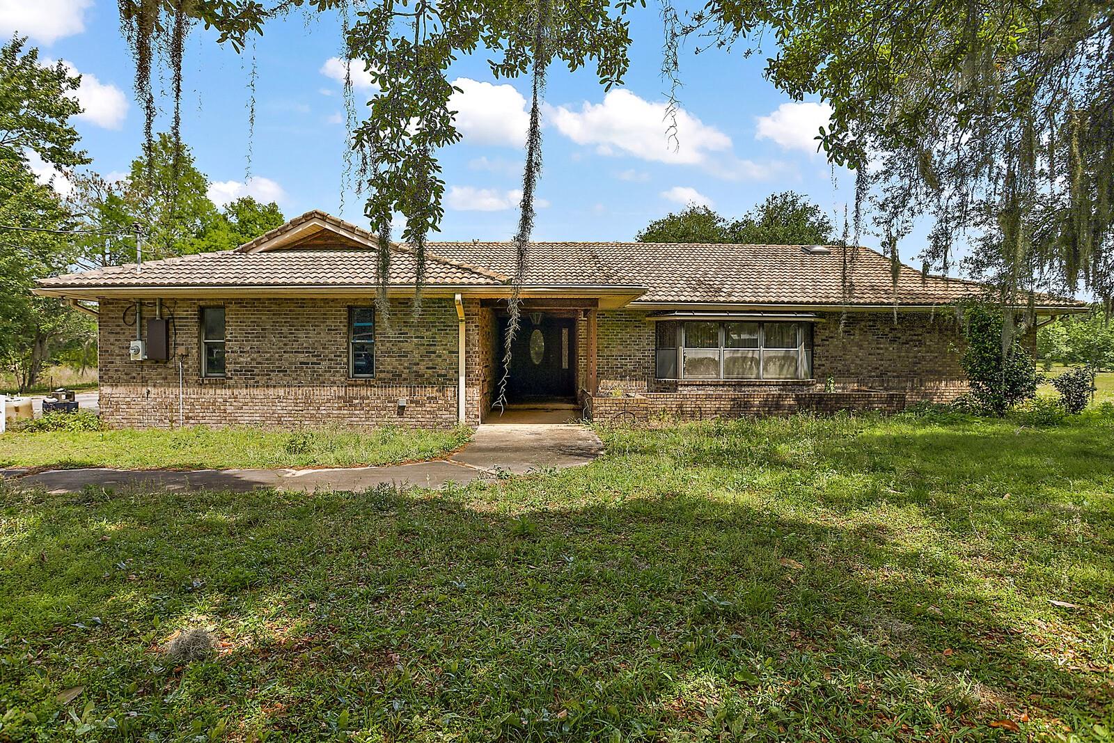 If you are looking for a great location with an opportunity to invest in, here is your chance! This property is located just minutes from UCF, Southwest of University Blvd and minutes away from Waterford Town Center, other shopping centers and restaurants. Convenient access to Hwy 408 and 417. Total of 11.34 acres which comprises of the following: 9.03 acres is zoned P-D and most of the land is cleared with a pond and includes a few outbuildings. In addition, there is another 2.31 acres with a pond to the left of the home and it is zoned A-2. This brick home is 2,784 sq ft and features 4 bedrooms, 4 bathrooms, solid hardwood flooring, custom kitchen cabinets, pool and a fireplace! Building restrictions require a 50 ft access in order to develop the P-D acreage for additional houses. Currently, there is a 15 ft access road off Buck. OWNER IS MOTIVATED! All measurements are approximate and should be verified by buyer/buyer's agent.
