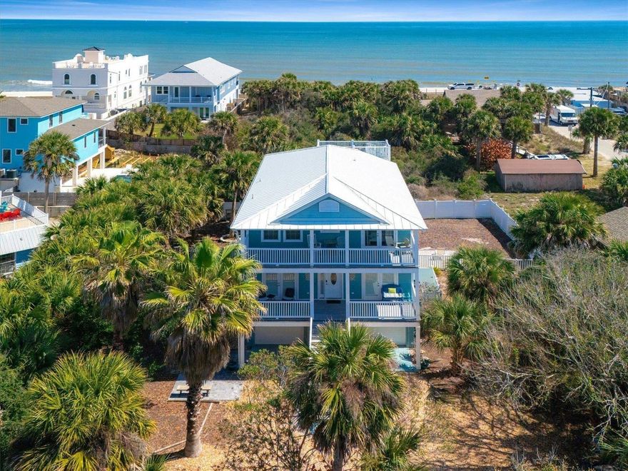 Experience the best of coastal living in this exceptional St. Augustine Beach retreat, where ocean views and direct beach access create a truly special place to enjoy your own piece of paradise. Perfectly positioned on a 1/3 an acre just steps from the ocean, this home invites you awaken to sunrises over the Atlantic and unwind with evening sunsets over the Intracoastal Waterway... the best of both worlds. With an open, flowing floor plan, expansive windows and sunlit rooms this thoughtfully designed home creates a welcoming environment for both quiet moments by the sea and gatherings. With 4 bedrooms, a bonus room and 3 1/2 baths there is ample space for both family and friends... An ideal home for unforgettable beachside memories with the ability to sleep up to 14 guests. Multiple low-maintenance Trex decks off of both the gathering areas and all bedrooms extend the living space outdoors, creating the perfect setting for enjoying the ocean breezes and Florida sunsets. The fully fenced spacious backyard provides a private retreat with plenty of room for a pool. Neutral toned pavers provide numerous areas to relax and enjoy your tropical oasis. Practicality meets convenience with an extra large two-car garage and extended front parking for up to four additional vehicles, a rare offering by the beach allowing plenty of room for hosting guests. Recent enhancement, including a new metal roof in 2024 and fresh exterior paint ensure peace of mind while complementing the home’s coastal charm and durability. Whether you’re searching for a serene personal escape, a place to gather for generations, or a property with the flexibility for short-term rental income, this home offers a unique blend of luxury, location, and lifestyle in one of St. Augustine’s most desirable beach communities. Concrete block construction.