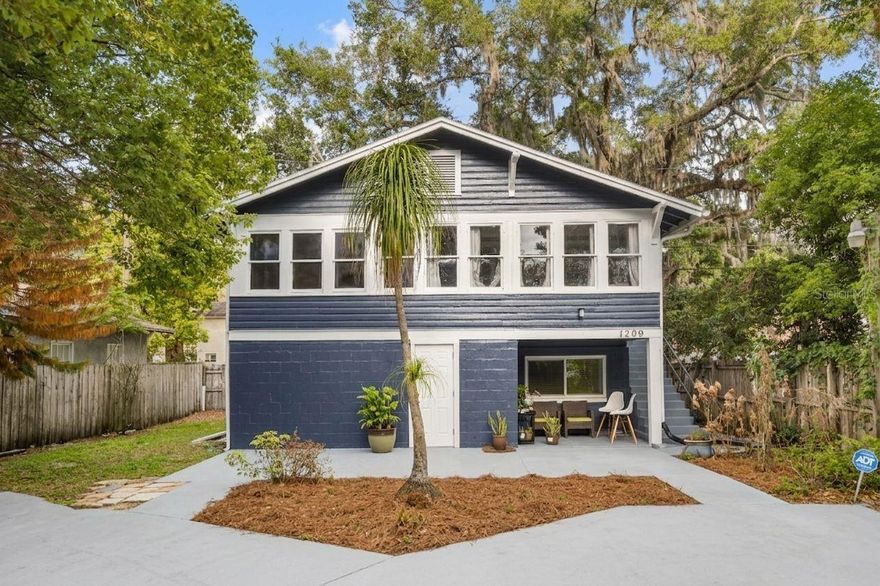 Currently occupied and income-producing with $3,025 in total monthly rent, 1209 S Myrtle Avenue Historic District — Sanford's golf cart neighborhood presents a compelling opportunity for investors seeking immediate cash flow along with long-term appreciation in a growing Sanford market. Nestled in an established neighborhood, the property is surrounded by mature trees and lush greenery, offering a private and shaded setting that stands out from typical properties in the area. The aerial perspective highlights the home's generous lot size and prime positioning, with convenient access to nearby roadways, local businesses, and everyday amenities. The exterior presents a distinctive two-story elevation with a spacious driveway and covered lower-level entry, creating both functionality and curb appeal, while the natural canopy enhances the peaceful residential atmosphere.
Inside, the home features a bright and inviting living area highlighted by expansive windows that fill the space with natural light and provide serene views of the surrounding greenery. The open layout flows seamlessly into the kitchen, creating an ideal environment for both everyday living and entertaining. The kitchen is designed with functionality and efficiency in mind, offering ample cabinetry, generous counter space, and a practical layout, complemented by natural light and clean finishes. An additional secondary kitchen area provides flexibility for extended use, multi-generational living, or added utility, enhancing the overall versatility of the home.
The bedrooms are comfortable and well-sized, offering flexible layouts suitable for a variety of living arrangements, including guest rooms or home office setups. Natural light and neutral finishes create bright, livable spaces, while the primary bedroom stands out with its spacious configuration and added room for seating or storage. The bathrooms are thoughtfully arranged with clean finishes and practical design, featuring a tiled shower surround, updated vanity, and well-lit layout that supports ease of maintenance and everyday use. A dedicated laundry and utility area adds to the home's functionality, providing convenient washer and dryer space along with additional room for storage and organization.
With $3,025/month in current rental income, a functional layout, and desirable Sanford location, this property offers strong tenant appeal and long-term upside through potential rent optimization or future improvements.