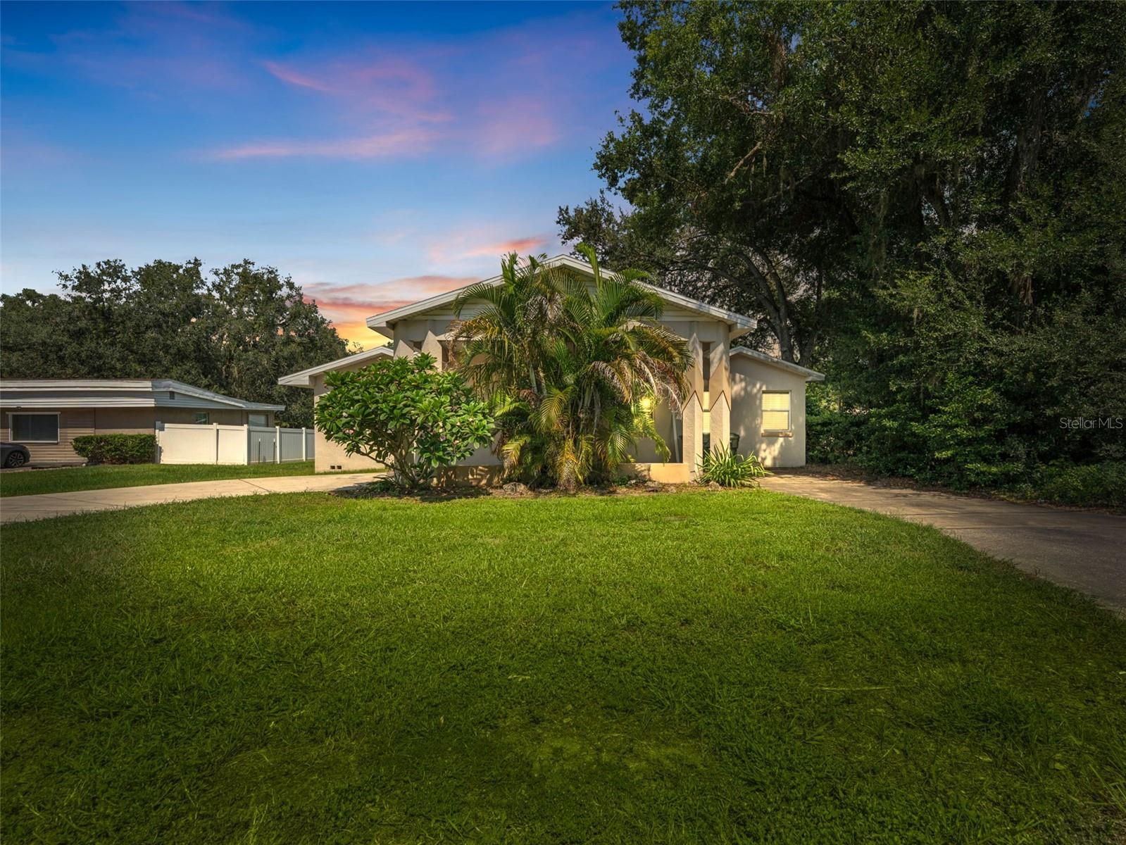 This home qualifies for a 1% lender credit with preferred lender. This home sits just blocks from Lake Hollingsworth and Florida Southern College, making it a prime opportunity for investors or homeowners seeking a strong college area rental. Inspired by Frank Lloyd Wright, the main house features 3 bedrooms, 2 bathrooms, and 1,941 sqft with a split floor plan, two living areas, and a gas burning fireplace in the formal living room. The open concept family room connects to the kitchen and overlooks the nearly half acre lot. A standout feature is the detached 1 bed 1 bath ADU built in 2017, complete with granite counters, shaker cabinetry, and handicap accessible doorways and bathroom, perfect for rental income, guests, or multi generational living. A large detached storage building/workshop adds even more utility.