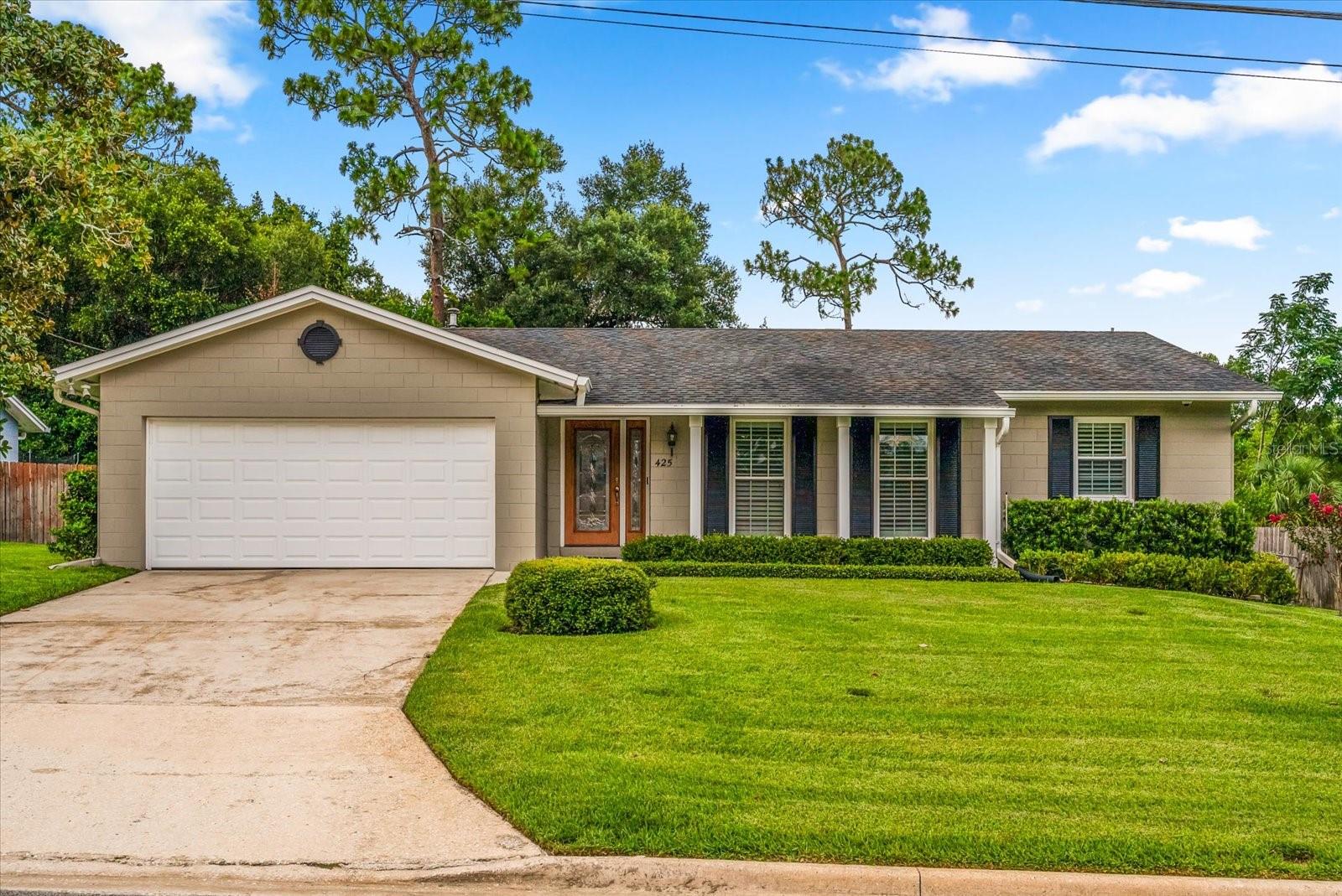 FULLY RENOVATED 3-bedroom, 2-bath ranch home in the heart of Altamonte Springs offering a rare combination of luxury finishes, smart technology, and timeless design. From the moment you arrive you will fall in love! The professionally painted exterior is framed by lush, professionally designed landscaping and a deep irrigation well that ensures vibrant greenery year-round. A wood-stained fiberglass front door with decorative leaded glass allows natural light to flow inside. Low-voltage brass landscape lighting highlights the foliage in the evenings. Inside, the home has been renovated with premium finishes at every turn! Crown molding, knock down ceilings, LED recessed lighting, and 18-inch porcelain tile are found throughout the main living areas and hallways. As you enter a formal living room and dining room provide plenty of room for entertaining, but the real show stopper is the custom kitchen and screened lanai. Step inside the gourmet kitchen FULLY RENOVATED IN 2018. It features an impressive suite of Thermador Professional Series appliances, including a 5-burner gas range with convection oven, a steam convection oven, a built-in microwave, French door refrigerator with bottom freezer, and a 3-shelf flex dishwasher. The kitchen is finished with quartzite countertops and backsplash, a designer composite undermount sink with disposal and a filtered water system, and CUSTOM REAL WOOD Thomasville cabinetry. Every detail was considered—from pull-out pantries and spice drawers to soft-close storage drawers, built-in trash/recycle bins, and upper cabinets with glass doors and interior lighting. The family room is open to the kitchen and offers double-paned sliding doors that open directly to the screened lanai. Step outside to enjoy a resort-style backyard that’s perfect for entertaining. The spacious lanai features a fully equipped summer kitchen with a built-in propane grill, running water with a stainless-steel sink, prep space, and stainless-steel cabinetry. A stone wall surrounds the space with travertine seating. The primary suite offers ceramic wood-look tile flooring and private access to the lanai. The ensuite bathroom offers a spa-like experience with a walk-in, fully tiled and lighted shower, a soft-close California Closet system, a built-in mirror, and a premium medicine cabinet with integrated lighting and USB ports. The two additional bedrooms offer full-size closets with adjustable shelving systems. The guest bathroom is equally well-appointed, offering a marble-topped vanity, full linen storage, Toto low-water-consumption toilet, custom lighting, and a walk-in tiled shower with custom frameless glass enclosure. The attached garage includes a fully insulated automatic garage door, an updated electrical panel (2018), a gas water heater, and a full-sized LG stackable steam washer and steam gas dryer. Tech-savvy owners will appreciate the smart garage lock integrated with the home’s alarm system, an EV charging-ready outlet, and a command center/patch panel pre-wired for high-speed fiber optic internet. ADDITIONAL UPGRADES include energy-efficient double-paned colonial-style windows throughout the home and custom-made poly-wood plantation shutters throughout from Sunburst Shutters of Orlando. Located just minutes from I-4, Uptown Altamonte, Cranes Roost Park, and top-rated Seminole County schools. Don’t miss your chance to experience the best of Altamonte Springs—schedule your private tour today.