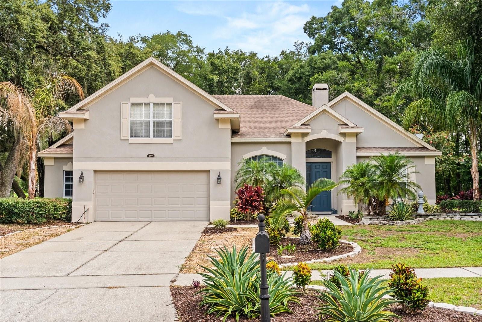 Welcome to 597 Sand Wedge Loop, a beautifully cared-for 4-bedroom, 3-bath custom home with a bonus room on a private 0.81-acre corner lot in the highly sought-after Rock Springs Ridge community in Apopka. Surrounded by mature oaks and peaceful garden pathways, this home offers the perfect blend of space, thoughtful updates, and timeless Florida charm. Step inside and you’ll be greeted by soaring ceilings and an open layout that feels bright and welcoming. A wood-burning fireplace anchors the main living area, creating a cozy spot for gatherings or quiet evenings at home. The spacious kitchen features plenty of cabinetry, two walk-in pantries, and generous counter space, making it a natural hub for entertaining family and friends. The oversized primary suite offers a relaxing retreat, complete with his and her walk-in closets and a spa-like bath featuring a garden tub, separate shower, and cedar-accented finishes. All bathrooms in the home have been tastefully updated with modern fixtures and rustic details that add warmth and character. This home has been well maintained with recent updates including a new roof (2017), two high-efficiency HVAC units (2023), and a new water heater (2023), providing peace of mind for years to come. Step outside to enjoy the beautifully landscaped yard with stone accents, a custom water fountain, a fenced play area, and a 12-zone irrigation system that keeps your outdoor spaces vibrant year-round. The oversized 2.5-car garage offers additional storage options, and underground utilities contribute to the clean, welcoming streetscape throughout the neighborhood. Located just minutes from parks, golf courses, shopping, and top-rated schools, this home offers the comfort and space you desire in a prime Apopka location. Come see how 597 Sand Wedge Loop blends Florida living, privacy, and convenience into one exceptional property you’ll be proud to call home.