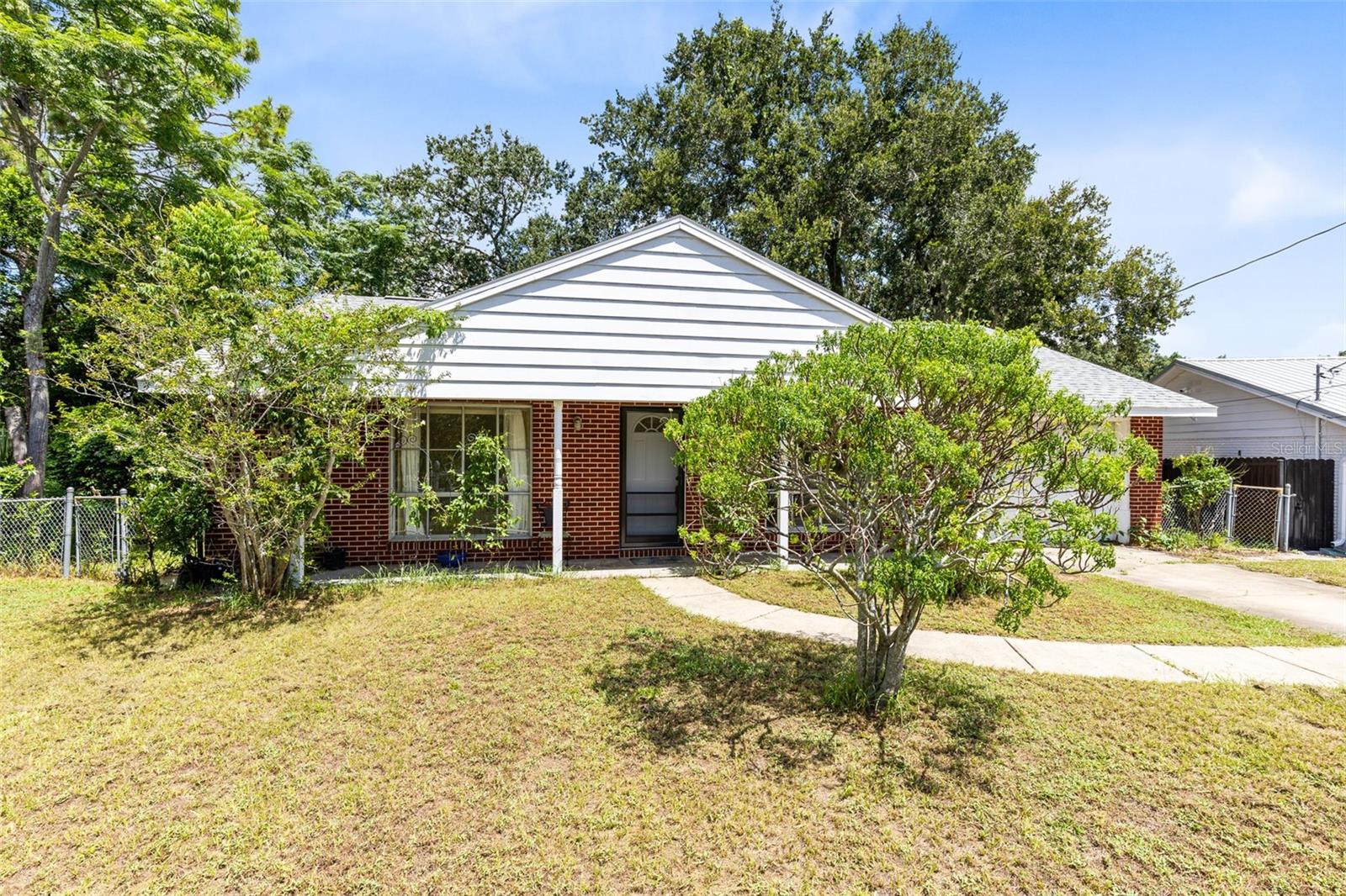 One or more photo(s) has been virtually staged. Welcome to 2030 Europe Ct, a charming brick home in the heart of Orlando, freshly repainted and thoughtfully updated for move-in readiness. Situated on a quiet cul-de-sac and backing up to a peaceful creek along the scenic Econ Trail, this home offers a very private, fenced backyard shaded by a beautiful canopy of old oak trees—keeping it cool and comfortable even during the hottest part of the day. A spacious deck provides the perfect space for relaxing or entertaining, and the yard features butterfly host plants that attract butterflies year-round, adding a vibrant, natural touch. Inside, you’ll find a cozy front living and dining area with carpet over terrazzo flooring, three bedrooms including a primary suite with dual closets, two linen closets, a coat closet, and an indoor laundry area for convenience. Major updates include a brand-new A/C (2023), a new roof with warranty (2023), and a newer hot water heater, offering peace of mind for years to come. With its prime location, serene natural surroundings, and solid updates, this home is a must-see.