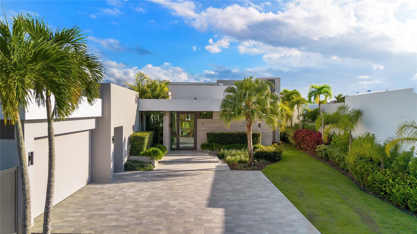Experience modern luxury at its finest in this Estate home located in The Isles at Dorado Beach, the newest and most exclusive community within the resort. With breathtaking views of the golf course and lake, this property stands out for its exceptional design and unmatched features, including a guesthouse with two additional bedrooms and bathrooms.
Spanning 4,065 square feet of interior air-conditioned space and approximately 5,200 square feet of total construction, this home sits on an expansive 1,259-square-meter lot, offering both spacious living and privacy.
The main house boasts an open-concept floor plan with high ceilings, a stunning Italian kitchen featuring Thermador appliances, a gas stove, and quartz countertops that beautifully combine elegance and functionality. Each of the four ensuite bedrooms provides comfort and privacy, while a stylish powder room adds convenience for guests.
The primary suite is a sanctuary, offering captivating views and direct access to an expanded terrace. Step into the outdoor living space, designed for entertaining, with a custom outdoor kitchen, a temperature-controlled pool and hot tub, and a poolside half bath with an additional outdoor shower. The primary suite’s spa-inspired bathroom includes double showers, a freestanding soaking tub, and a private outdoor shower, creating a serene retreat.
The guesthouse, connected by a covered terrace, is perched on the second story and offers two ensuite bedrooms with floor-to-ceiling glass doors and windows, perfectly framing the panoramic views of the lake and golf course. This space is ideal for hosting guests or multi-generational living.
Adding to the convenience of living in The Isles at Dorado Beach, the community features a state-of-the-art power generator that ensures uninterrupted power, giving you peace of mind without the hassle or maintenance of owning a personal generator.
Professionally decorated by a luxury interior designer and sold turnkey, this home is ready for you to move in and enjoy resort-style living.
With limited availability of homes offering views of this caliber, this is a rare opportunity to own a truly exceptional property in The Isles at Dorado Beach. From its thoughtfully curated interiors to its breathtaking outdoor spaces, this estate has everything you need and more.
Schedule your private tour today—this home is destined to be in high demand!