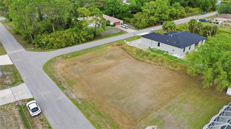 Build your dream home on this cleared corner lot tucked into a quiet area of North Port with newer homes nearby. Offering both privacy and flexibility, this property is well-suited for a variety of home designs.

The corner positioning provides dual frontage, allowing you to build on either the longer or shorter side of the lot and choose a northern or western-facing home orientation based on your preferences.

Located in Flood Zone X. With the lot already cleared and survey available you can move directly into planning and construction.

Well and septic will be required, which is typical for the area.

Conveniently located with easy access to US-41 and I-75, and approximately 8 miles from Downtown Wellen Park. Shopping, dining, and everyday amenities are nearby throughout North Port and Port Charlotte. The North Port Aquatic Center and local parks are close by, and schools serving elementary through high school are located within approximately 3 miles (buyer to verify). Gulf Coast beaches are approximately 30 minutes away.