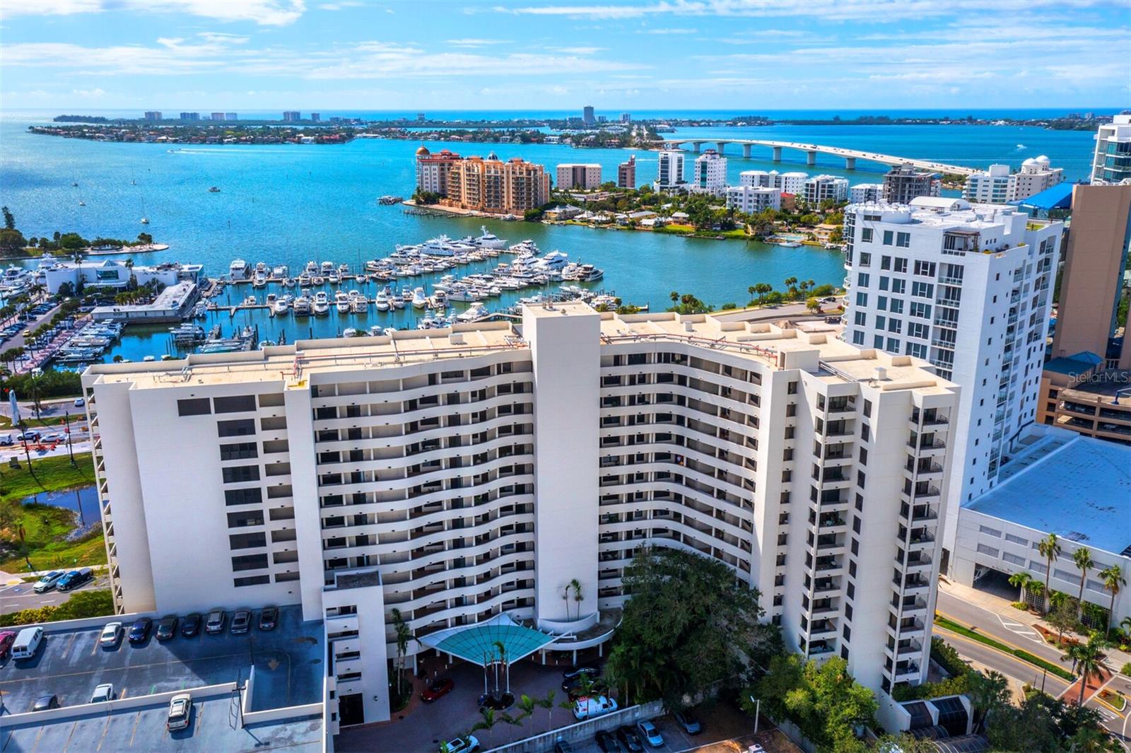 Conveniently located in the center of downtown, architect Tim Seibert designed Bay Plaza with full, unobstructed views of Marina Jack, as well as unparalleled views of the Sarasota Bay skyline. This two bedroom and two bath residence boasts 1,656 square feet of living space, which opens to the waterfront balcony. The terrace extends the open floorplan to enhance the space and highlight the gorgeous sunsets. The entrance leads to an open living room and dining room perfectly situated for entertainment. The kitchen offers a breakfast bar, solid counter tops, stainless steel appliances, and wood cabinets. A separate laundry room is located just off the kitchen with glass pocket doors and built in cabinets for extra storage, and could even double as a small office space. The master suite also has stunning bay views and features a large, luxurious master bathroom, and walk-in closet. The split floorplan offers privacy with an office in the guest room that easily transitions into a bedroom with a built-in murphy bed, and terrace access. The sliding doors have been replaced with hurricane rated doors and all the windows are scheduled to be replaced in June. Bay Plaza offers full services including: 24-hour concierge, valet parking, a heated pool and spa, a well-appointed fitness center, sauna and steam rooms, and EV charging stations. Residents will appreciate bonus features such as: hurricane shutters and a pet-friendly residence. Assigned garage parking for two cars and plenty of extra spots ensures easily transitions. This spectacular residence with a prime location allows appealing access to an abundance of excellent dining venues, cultural events, gorgeous beaches, St. Armand’s Circle, and Longboat Key.