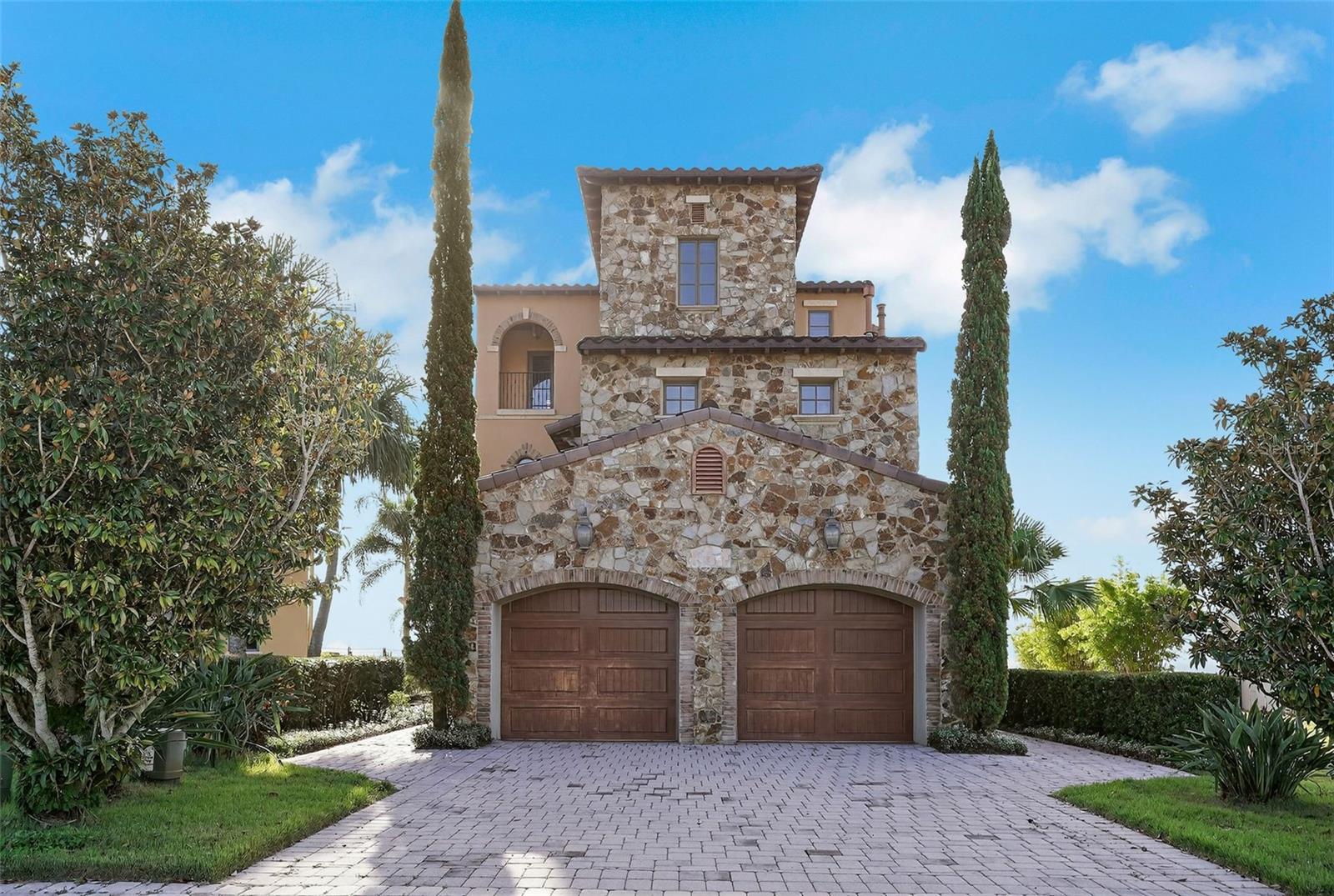 Gorgeous 3 Bedroom 3 Full Bathroom 2 Half Bathroom w/Theater Room & Elevator Located Atop the 18th Fairway in the Exclusive Guard Gated Community of Bella Collina with the MOST SPECTULAR VIEWS!!! This Tuscany inspired home offers luxury and tech smart home living with an additional Office, Bonus Room, Wine Room, Private Elevator to all 4 floors, and a Separate Golf Cart Garage. The Gourmet Kitchen built for a Chef features stone countertops, real wood cabinets with built-in stainless-steel appliances including the refrigerator, range, double wall oven and microwave. The French doors off the kitchen lead to a covered outdoor entertaining space with an amazing fireplace display, which overlooks the stunning courtyard and its three-fountain display. The Penthouse Style Primary Bedroom Suite offers a private bathroom with dual sinks/separate vanities, a jetted soaking tub, and a walk -in closet the size of a bedroom along with a balcony offering the best views in the house from the top floor. This is an AMAZING property that has been well maintained and will definitely impress any and all visitors while they enjoy the breeze off the lakes and gaze at the views from any balcony in the home. The Bella Collina community offers a Luxury Country Club lifestyle with a wonderful golf course, pro shop, clubhouse, spa, pool, fitness center and locker rooms. The location is prime just minutes from everything imaginable. Please call to schedule a showing today!