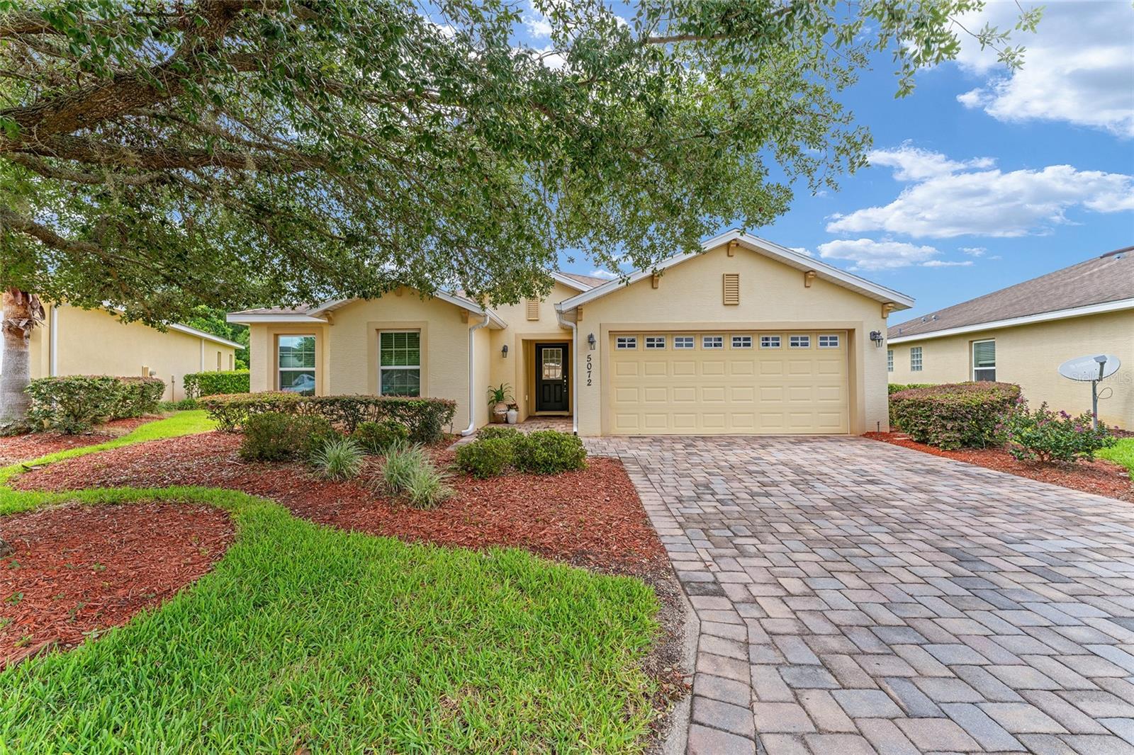 This Charming home is situated in the highly sought-after Gated Community of Lakeside Landings. The spacious Osprey floor plan with 3 bedrooms and 2 bathrooms lives larger than the square footage. One of the best locations in the area. Just a 12-minute golf cart ride to Sumter Landing, 15+ minutes to Spanish Springs, and less than 10 minutes to most of the conveniences in the area – several grocery stores, medical, dental, the new Home Depot, Lowe's, and the future Costco and Target, and so much more. The home welcomes you with its mature landscaping, maintenance-free lawn, STUCCO exterior, and PAVER walkway and driveway. Inside, you'll find an OPEN-CONCEPT with 10-foot HIGH CEILINGS in the main living areas. This home has CERAMIC TILE FLOORS throughout the main living areas. The large open EAT-IN kitchen has solid wood cabinets, a breakfast bar, and GRANITE COUNTERTOPS, while the dining room area provides additional space for hosting gatherings. The primary bedroom has an en-suite bathroom has dual sinks on the single vanity, a tiled walk-in shower, and a LARGE walk-in closet. The split-bedroom layout includes two generously sized guest rooms, a shared bath, and a separate linen closet, perfect for guests or family. Enjoy your LANAI, which overlooks the private backyard that has more than enough room for a pool. The 2-car garage offers ample space for your golf cart and other personal vehicles with ample room. Additional storage for seasonal items over the garage space. The HOA takes care of exterior pest treatment, lawn care, and irrigation (free lawn watering) to ensure a maintenance-free lifestyle. This is a TRULY GATED COMMUNITY featuring impressive wrought iron gates, boasting two pools including a relaxing RESORT-STYLE POOL, two in-ground Jacuzzis, a clubhouse with a library, billiard room, a FULL FITNESS CENTER, space for community events, a card room, putting greens, playground, basketball, tennis, and pickleball courts exclusively to residents. If you enjoy kayaking and sunshine, you will love the access to Lake Miona. NO BOND.