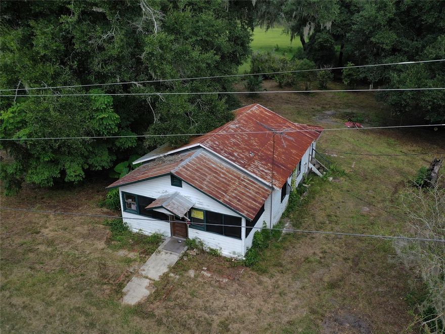WELL AND ELECTRIC ON SITE. Rural country lifestyle! Located in the “Fern Capital of The World”  (Pierson) This home sits on just under 5 acres of private property surrounded by natural Florida wildlife. With your custom touch and renovation could be the perfect retreat or forever home with quiet enjoyment. There is no better place for peace and quiet than hiking or riding through your own trails on property. The best part is this home is on a paved road; a straight shot (4 miles) to the St Johns River and boat ramps. Plenty of room to store your boat and toys! Survey is recent and able to be provided.