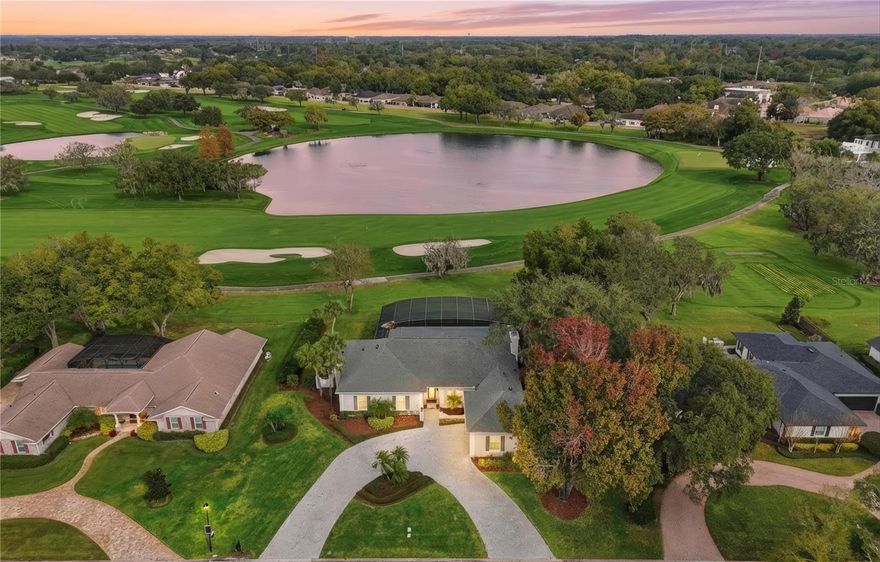 Completely re-imagined, this home offers a rare opportunity to experience turnkey luxury living on the 11th fairway of the renowned Bay Hill Championship Golf Course, with panoramic water views and stunning glimpses of the 11th, 12th, 13th, and 14th holes. Nestled in the highly desirable Bay Hill neighborhood, this home has been carefully updated and elevated to a luxury residence, where every detail has been thoughtfully considered, perfectly blending modern finishes with timeless elegance.
The gourmet kitchen has been fully redesigned with quartz countertops, a beautiful designer backsplash, brand-new appliances, and an open layout that flows seamlessly into the newly opened-up family and living room areas—ideal for entertaining or everyday living. Throughout the home, all-new flooring—including travertine, marble, and refinished oak—blends sophistication with comfort. New designer light fixtures and fans throughout. Fresh interior and exterior paint complete the turnkey presentation.
Inside, the home showcases 11-foot ceilings, wainscoting, crown molding, and custom architectural details, creating a seamless flow between grand entertaining spaces and cozy, intimate areas. The family room features a marble-hearth fireplace, and French doors open to the pool area from the living and family rooms, while transom windows fill the home with natural light.
The primary suite offers a serene and spacious retreat, with new marble floors, a large sitting area, and huge picture windows offering beautiful fairway views, perfect for relaxing or working from home. The primary bathroom features durable travertine flooring, dual sinks, a soaking bathtub, a separate shower, and a large walk-in closet, completing this refined and functional suite. Two additional bedrooms share a Jack-and-Jill bathroom, while the remaining bedroom has its own en-suite bath.
Step outside to your screened-in oasis with a nearly 41-foot lap pool, huge covered patio, and a new outdoor bar area ideal for entertaining or enjoying the Arnold Palmer Invitational poolside, framed by stunning sunset views. The oversized two-car garage has a new floor coating and a rear-entry golf cart door for direct course access.
Life in Bay Hill offers more than a home—it’s a true community experience. Residents may join the Arnold Palmer Country Club, featuring world-class golf, tennis, pickleball, a marina on the Butler Chain of Lakes, fitness center, heated pool, and three dining venues, including the newly renovated Bay Window. Just minutes away are Sand Lake’s Restaurant Row, Disney, Universal Studios, major thoroughfares, and top-rated schools.
This home is fully updated, turnkey, and ready—where the championship golf course lifestyle meets the elegance of an elevated luxury residence, with every detail thoughtfully crafted for upscale golf  living. Now available!