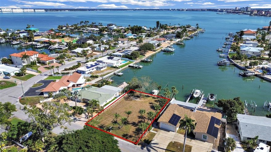 A rare opportunity to craft a luxury waterfront residence in the Belle Vista community of St. Pete Beach. This exceptional buildable lot offers 80 feet of deep-water frontage on Nicholson Bayou, a protected and tranquil waterway ideal for safe, year-round mooring. Enjoy seamless access to Boca Ciega Bay and the Gulf of Mexico from a deep-water dock designed to accommodate large sailboats or yachts. A current permit is in place, and the seller will install a new reinforced seawall engineered to support a future swimming pool, providing exceptional confidence and flexibility for your custom build. Wake up to breathtaking sunrises over Boca Ciega Bay, and walk to award-winning beaches, fine dining, and boutique nightlife. This is the perfect setting for an exceptional coastal estate—where luxury waterfront living truly begins.