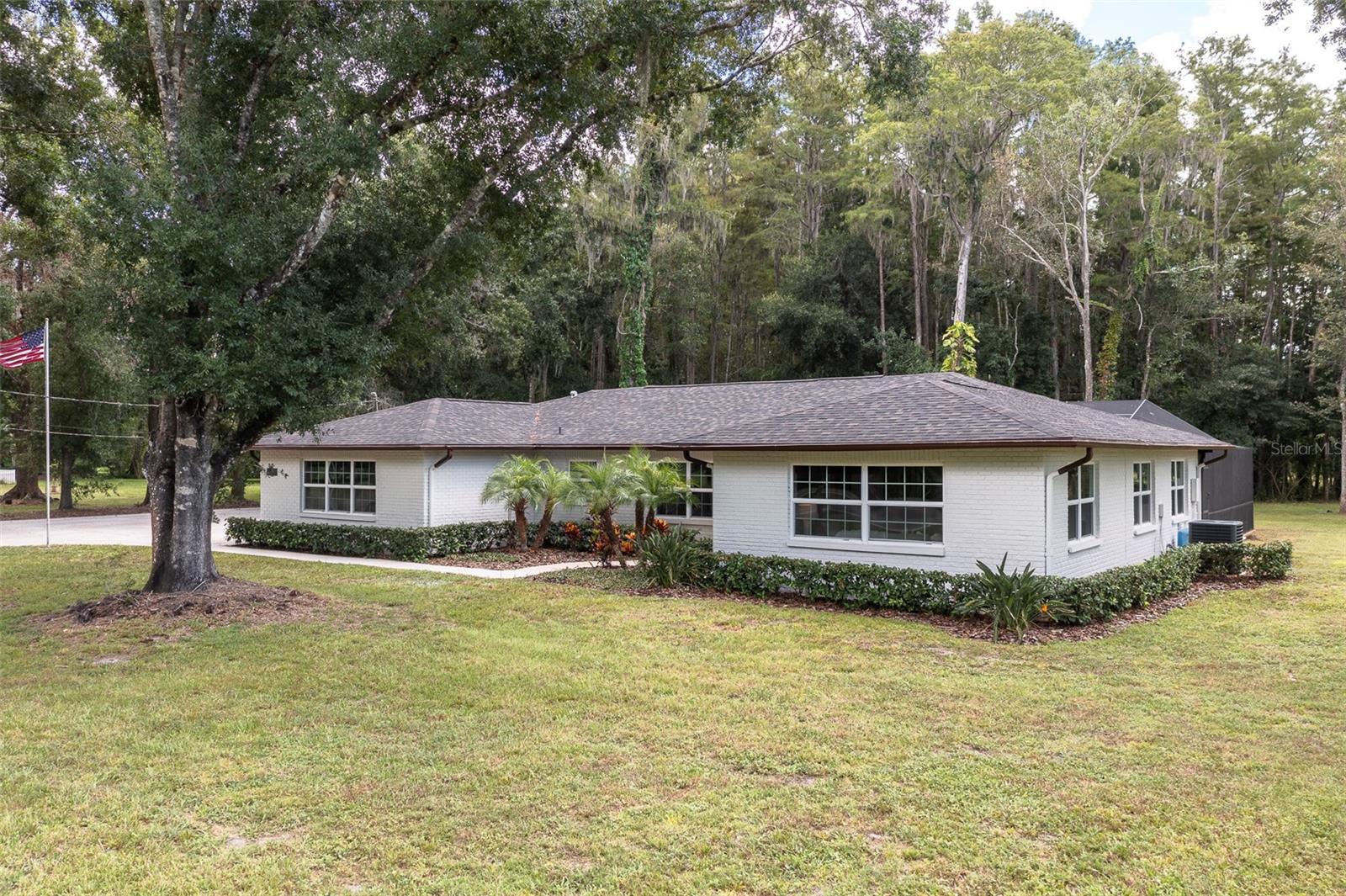 Welcome to 3490 Old Keystone Road, located in a highly desired area of Tarpon Springs, Florida. This magnificent property offers a perfect blend of luxury, comfort & serene county living. Nestled on a gorgeous 2.37-acre equestrian-friendly parcel with the renowned Brooker Creek Preserve horse trails just across the street. This unique property offers an unapparelled connection to Florida's natural beauty where majestic deer, sandhill cranes & wild turkey are frequent visitors. Step inside and prepare to fall in love. Beautifully updated throughout, this 4-Bedroom, 2.5-Bathroom showstopper spans 2,454 sq ft, all on one floor with ample living and dining spaces, including a welcoming living room, formal dining space, a cozy breakfast nook and a separate family room for relaxation & gatherings. Another attractive feature is the large bonus room, which has its own entrance, making it an ideal space for an in-law suite or home office. The interior showcases wood look, tile flooring that combines the warmth and charm of hardwood with the durability and easy maintenance of tile. The kitchen is a dream- newly updated with granite countertops, crisp white cabinetry, farmhouse-style sink with goose neck faucet, large closet pantry and a French door refrigerator. The master suite is spacious with a great view of the backyard and so private you could leave the blinds open all the time. The master has a large walk-in closet, ensuite bathroom with walk-in shower & sliding doors that overlook the tranquil pool. This home has generous sized rooms with so much versatility, plus a split bedroom plan for privacy. There's lots of closet space throughout the home and an inside laundry room. As you step outside, you'll be welcomed to your own private oasis: an expansive screened-in lanai with a sparkling swimming pool, perfect for you to cool off on warm afternoons & simply relax and unwind. Don't forget to take a stroll down the shaded, tree lined road to the back of the property where you'll find a peaceful pond & big red barn. The 40'x40' concrete block barn makes a fantastic workshop, with water & electric and lots of space to accommodate any hobby. Bring the RV, boat, pets and all the toys, there's no deed restrictions or HOA here. The home has county water and a private well to use for animals & irrigation. Roof is only 3 years old. New Windows in 2020 and new sliding door in 2025. Property is in Flood zone X, no flood insurance required. Located in a top-rated school zone. This truly is a natures paradise, offering a rare blend of rural living with all the convenience. SELLER FINANCING AVAILABLE, call for more details. This one isn't going to last long, give me a call today to schedule your private showing.