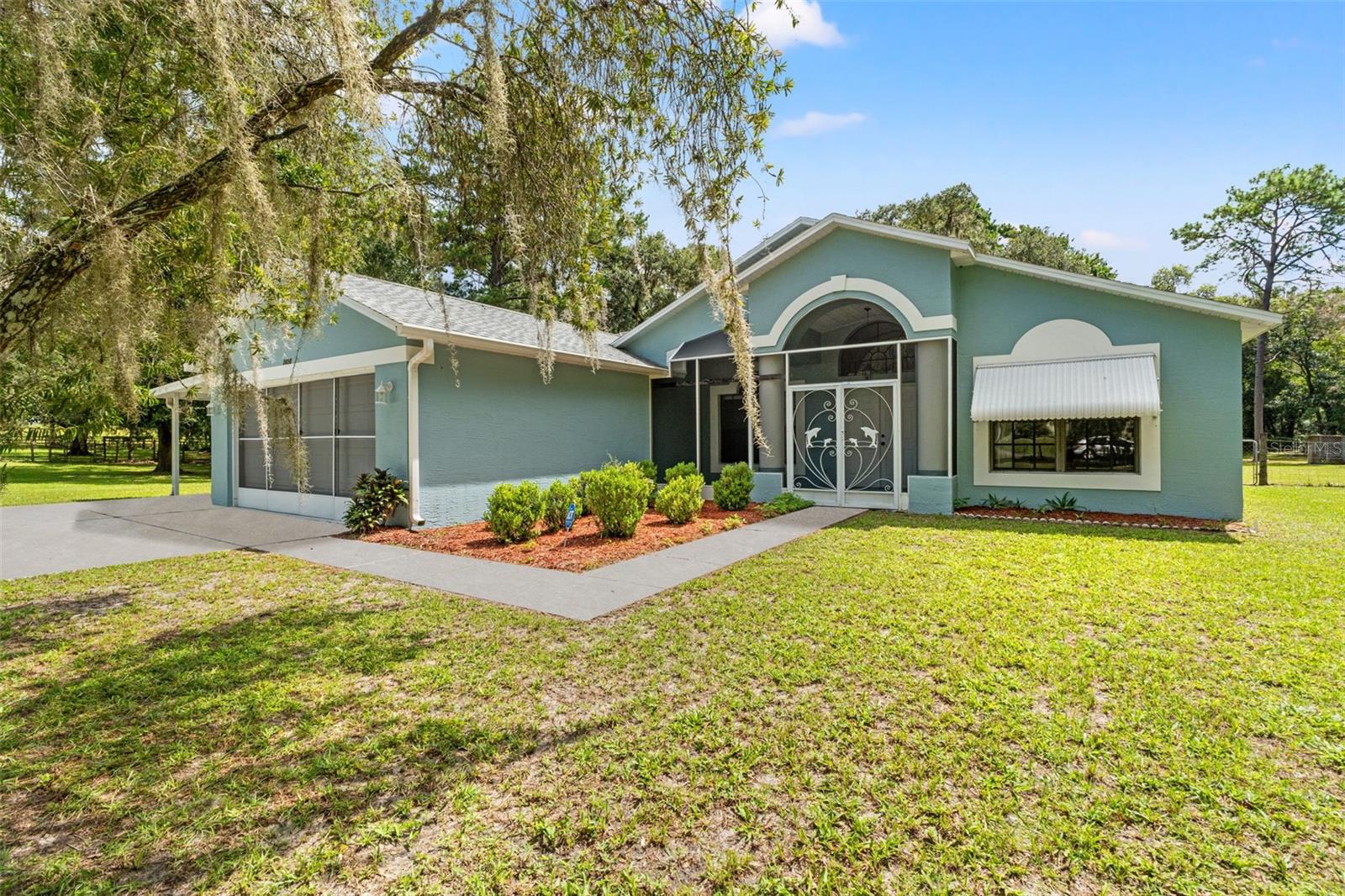 Looking for acreage paired with an adorable, well-maintained home? Look no further! Nestled among mature shade trees in one of Hernando County's most sought-after and peaceful neighborhoods, this charming 3-bedroom, 2-bathroom home sits on 2 fully fenced acres in the heart of Brooksville. Enjoy the peace of mind that comes with major updates already completed, including-- Roof (2019), AC (2020), Water heater (2020) and updated septic system and drain field (2023). As you arrive, you'll be greeted by scenic views and a sense of serenity. The oversized driveway leads the way to the spacious screened-in front porch, welcoming you into the home through double doors, where you'll find soaring cathedral ceilings and abundant natural light throughout. The open floor plan features newer tile flooring, creating a fresh, modern feel. The owner's suite is thoughtfully located on one side of the home for added privacy and includes two oversized walk-in closets, a spacious ensuite bathroom, and direct access to the lanai. On the opposite side of the home, ideal for privacy, you will find two generously sized guest bedrooms, both with ample closet space and large windows. The updated guest bathroom (2024) includes a brand-new vanity, tiled shower, and flooring. In the back of the home is an oversized Florida room, a perfect place to create an office, playroom or gym. This massive space opens to the real showstopper! The backyard oasis. This gorgeous, expansive lot offers endless opportunities for outdoor enjoyment—whether it's a creating a garden, watching nature or enjoying Florida this serene space has it all! An oversized storage shed with electricity and 2 chicken coops to bring country living to life, as well as a fire pit! Zoned Residential Agricultural, to enjoy livestock and opportunities with the land! Some other great features, there is an additional carport, a freshly painted garage floor, and hurricane shutters. With being less than 10 minutes from downtown, and close to I-75, you are surrounded by everything you could desire! This rare gem won't last long. Schedule your private showing today and make this peaceful retreat your new home!