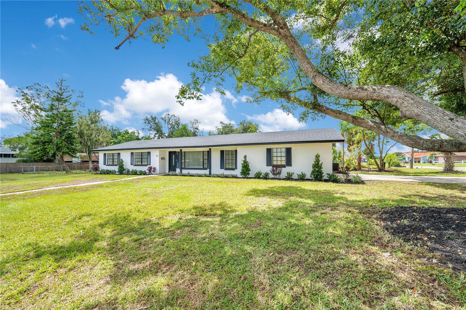 Beautiful 4 Bedroom, 2 Bathroom block construction home on a huge corner lot with No HOA. This property has been completey remodeled and is completely move in ready. The home features an open floorplan with a formal dining space, large living room and a huge gourmet kitchen with quartz countertops, a full closet pantry, stainless appliances and a breakfast nook, as well as a large indoor laundry room, luxury vinyl plank floors throughout, fully remodeled bathrooms with custom porcelain tile. There is also Brand New Roof! The 4th bedroom could also serve as a bonus room or office. There is also a den off the back of the home with tons of natural light and full AC. Perfect for enjoying the huge backyard and mature landscaping. There is also a large detached storage barn in addition to the full size attached 2 car garage and oversized driveway. A fully remodeled home that is not in a cookie cutter subdivision is a rare find in the Auburndale market today and espicially at this price point. Schedule your shopwing today while it is still available!