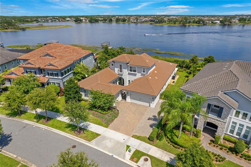 PRICE REDUCED ! Get ready to enjoy the luxury and lifestyle in your stunning lakefront home with 115 feet of pristine shoreline. Sweeping views of skiable Lake Hancock during the day, Disney Fireworks at night. 2019 built, over 4000 Square feet and 4 Bedrooms, a dedicated office, bonus Room with bathroom and closet, 5 total bathrooms and 3 car garage. Enter the home through a gated courtyard with a custom concrete gas fireplace. Through the front door, enjoy immediate views of the beautiful pool and lake. Formal dining room to the right and straight ahead to the open family room and kitchen, with eat in area and lots of natural light. The large kitchen island features a farmhouse sink and beautiful quartz counter and built in shelves. Double stacked cabinets above designer glass backsplash. GE Monogram kitchen appliances 42" built in refrigerator and 36" gas cooktop. The primary suite has its own large seating area with views of the lake. The spa like master bathroom offers a glass tile walk in shower, oversized soaking tub and custom closets with separate back entrance to the laundry room. Down the hall is the office and another bedroom with ensuite bathroom. On the opposite side of the home are the oversized secondary bedrooms, each featuring its own vanity and a shared jack and jill tub and shower area. The pool/guest bathroom is perfect for easy access from outdoors or can be used as bath for a bedroom. There is a huge upstairs bonus room with its own full bathroom and large storage closet and could be used as in law suite. Wood floors and designer glass tile and quartz counters in every bathroom are among the additional upgrades. The oversized salt water pool offers fiberoptic lighting, a sun shelf and spa and two large fire bowls. The multi level travertine deck also features an additional extra large fire bowl. Sit on the deck and enjoy the breathtaking views and Disney fireworks at night. Overlook at Hamlin offers a resort style pool, clubhouse with fitness center, Tennis courts and is located near major highways, theme parks and with easy access to first rate hospitals and medical care. Be sure to click on the virtual tour links
<div style="padding:56.25% 0 0 0;position:relative;"><iframe src="https://my.matterport.com/show/?m=zbGecP5Mnku&mls=1" frameborder="0" allow="autoplay; fullscreen" allowfullscreen style="position:absolute;top:0;left:0;width:100%;height:100%;"></iframe></div>
<div style="padding:56.25% 0 0 0;position:relative;"><iframe id="vimeo-983727383" src="//player.vimeo.com/video/983727383?width=640&height=360&color=00adef&portrait=0&title=0&byline=0&autoplay=0&loop=0&showinfo=0&player_id=vimeo-983727383" frameborder="0" webkitAllowFullScreen mozallowfullscreen allowfullscreen style="position:absolute;top:0;left:0;width:100%;height:100%;"></iframe></div>