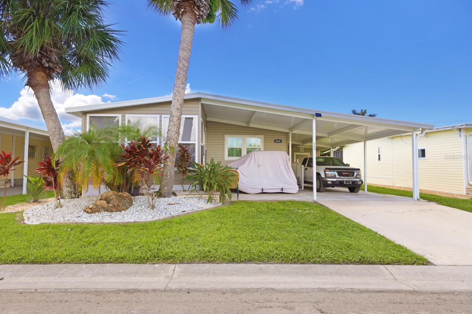Super Cute Move-In Ready Home in Golfing Community! Welcome to this charming and beautifully updated 1983 manufactured home, perfectly nestled in the vibrant golfing community of Maple Leaf Golf and Country club where the amenities never end. One of the 4 heated pools and the covered hot tub are just a short distance away at this location. This 2-bedroom, 2-bath gem has been lovingly cared for and thoughtfully renovated with luxury vinyl plank flooring, a 2023 roof, 2023 air conditioner, and 2023 carport PLUS newer windows to let in plenty of sunshine. ALL THE BIG TICKET UPDATES ARE DONE! Enjoy peace of mind and modern comfort the moment you walk through the door. Inside, you’ll find a light and airy open layout since the kitchen wall was removed to give you the open concept feeling that is so desirable now. The dining room and living room both have custom plantation shutters for that extra touch of elegance. The spacious kitchen and living areas make entertaining a breeze, while the primary suite offers a relaxing retreat with its own private bath. Home is being sold partially furnished and the golf carts can be purchased outside the sale of the home. Outside, the LARGE BACKYARD sits on a dog-friendly lot (breed restrictions apply), perfect for enjoying the sunshine with your four-legged friend. Whether you're teeing off in the morning, hitting the pickleball/tennis courts or enjoying a sunset walk, this welcoming community offers the lifestyle you’ve been looking for. Don’t miss this opportunity to own a move-in ready home in a friendly neighborhood where golf, comfort, and convenience meet! In Maple Leaf you'll enjoy over 75+ clubs and activities, 4 heated swimming pools, 2 hot tubs, 5 tennis courts, 4 pickleball courts, 2 shuffleboard courts, 2 restaurants, tiki bar, golf course, woodworker shop, fitness center and so much more. In Maple Leaf they say, "If you're bored, it's your own fault!"
