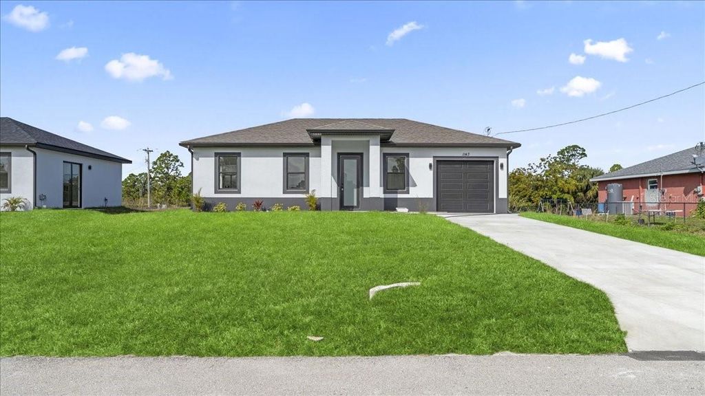 Photo of 1143 Barfield Street E, Lehigh Acres, FL 33974 (MLS # TB8487564)