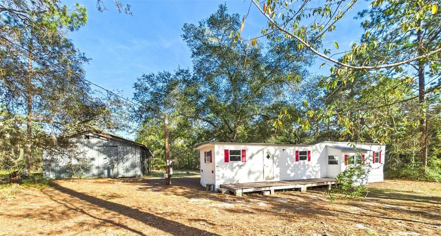 Nestled in the peaceful woods of Forest Lakes Park, this .92-acre property offers the ultimate in country living. Surrounded by nature, this beautifully updated single-wide home has been completely renovated inside and out, creating a cozy, move-in ready retreat that feels fresh, modern, and full of charm.

Step outside to find your very own 20x24 covered workshop, ideal for projects, storage, or hobbies, along with an additional 36x24 covered extension that provides plenty of space for all your toys, tools, and outdoor gear. Whether you’re working on a project or relaxing under the shade, this property is designed for both comfort and functionality.

Bring your ATVs, side-by-sides, and adventurous spirit because this is true country living at its finest. The surrounding landscape offers endless opportunities for outdoor fun, exploration, and a peaceful way of life.

This property can also be purchased together with MLS# G5102247, and pricing can be negotiated accordingly for those seeking additional space or investment potential.

Experience the freedom and tranquility of rural living with the convenience of being close to all that Marion County has to provide.