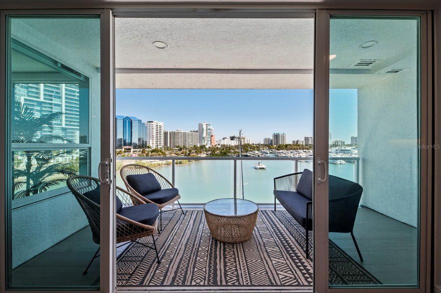 Fully Remodeled Sarasota Bay front with 40’ Private Boat Slip on Golden Gate! Welcome home to the 2017 award-winning renovated boutique bay front condominium, Harbor View. This near top level highly sought after center unit has it all – unobstructed views of the Sarasota city skyline, captivating views of Marina Jacks yacht harbor and comes complete with prized deeded deep-water boat slip that can accommodate a 40 foot motor boat or sail boat. The boat slip also includes a high-capacity Deco Concept 20,000 pound lift, a shore locker cabinet, lighting, water and shore power connections. Step out from the main balcony or your private master suite balcony, breath in the fresh air and enjoy your morning coffee or favorite evening beverage while you take in the city sky-line, watch for the occasional dolphin or watch the yachts’ moving in and out of the marina. This chic-contemporary 5th floor unit was recently renovated in 2023 and comes complete a secure private elevator entry that steps directly into your unit which opens to two bedrooms, two and a half bathrooms, a den/flex room with built in Murphy Bed (for those overnight guest) luxurious residence. Stepping out of the elevator into your home you are greeted with an open living area with souring floor to ceiling views of the Sarasota Bay all around. Entertain your family and friends in the newly renovated chef’s kitchen with the city skyline behind you. The kitchen has been expanded and re-configured to include Thermador appliances (including a gas range) spacious one level center island with quartz countertops and island hidden storage. Two-toned high-end cabinetry fill nearly every corner of the redesigned kitchen and allows the perfect place for all of your kitchen wears. Quartz counters fill in the remainder of the counter space as well as the providing the perfect complimenting back splash under a warm under cabinet light glow. Escape the day into your expanded master suite with complimenting bay/city view balcony and two walk in closets with built in closet systems. The master bathroom has been completely renovated to magazine level design and boast floor to ceiling porcelain tiles, gold accent and fixtures, overhead rain shower, dual vanities with beautiful high-end cabinetry with granite countertops. The interior second bedroom has new tile, built-in walk-in closet system and a chicly renovated en-suit bathroom. Harbor View comes with a dock side heated pool/spa and outdoor sitting areas feature umbrella-covered tables and chairs and a barbecue. The recently updated outdoor paved area offers loads of space to work on your golden Florida tan or relax after a full day of boating. There are 2 gated and assigned under-building parking spaces and guest parking on the street affording plenty of visitor parking for your friends and family. This amazing downtown location offers easy access to all the outdoor recreational activities you would expect living on the water. In addition, the condominium is in easy walking access to art shows, boat shows, an array of theater options, Main Street shopping and dining. St Armands shopping and the beautiful beach of Lido Key and dining are just minutes away. This home is the perfect blend of luxury, active lifestyle and the boating life unique to Sarasota. *A new dry bar is being installed in March 2024 (see PDF) and will include the wine cooler