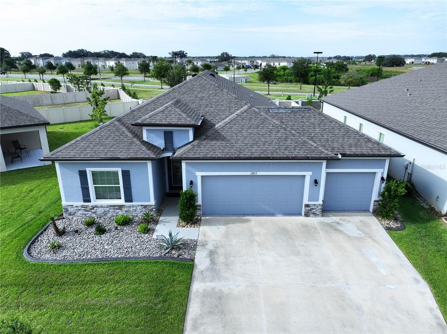 One or more photo(s) has been virtually staged. THIS IS IT!  Welcome HOME to this stunning “Miramar” floor plan by Maronda Homes LOADED with premium UPGRADES and showcases beautiful Floridian-style architecture with stone accents, decorative shutters, and exceptional curb appeal.  This AMAZING HOME is located in the highly sought-after Mirada LAGOON Community, the nation’s largest 15.2-Acre Crystal Lagoon and one of Florida’s TOP-selling master-planned communities.  STEP through the custom 8’ Full-Lite entry door into an elegant FOYER featuring a double tray ceiling with crown molding. The thoughtfully designed OPEN-CONCEPT layout seamlessly connects the MAIN LIVING areas, creating the perfect space for entertaining and everyday living. Ceramic wood-look tile flooring and crown molding enhance the main living areas throughout the home.  The Kitchen is truly the HEART of the HOME, highlighted by an OVERSIZED 9’ Carrera Marmi quartz island with breakfast bar seating, 42” upper cabinets with crown molding, soft-close drawers, subway tile backsplash, and pantry with custom built-in shelving. The Dining area is accented with decorative mirrored wall panels, adding a touch of sophistication for special gatherings and holidays.  The spacious Living Room features triple sliding glass doors that open to your PRIVATE BACKYARD OASIS.  Enjoy Florida living year-round with a covered lanai, extended screened patio, additional open patio space.  The expansive backyard offers endless possibilities for future outdoor enhancements.  Privately located at the rear of the home, the luxurious OWNER'S SUITE features a tray ceiling with crown molding and a custom walk-in closet system complete with built-in drawers, shelving, and storage baskets.  The spa-inspired EN SUITE bathroom includes quartz make up vanity, soft-close cabinetry, a soaking tub, floor-to-ceiling tiled walk-in shower, and linen storage.  This 3-Way Split Floor Plan provides excellent privacy and flexibility.  Three generously sized secondary bedrooms are positioned toward the front of the home with abundant natural light and ample closet space.  Bedrooms two and three share a beautifully appointed secondary bathroom featuring a quartz vanity and tiled tub/shower combo with framed sliding glass doors.  The fourth bedroom offers versatility as a home office, flex room, or guest suite.  The inside Laundry Room has cabinets and includes LG Thin Q washer & dryer.  •FEATURES: •Smart Home IQ system controlling alarm, thermostat, and video doorbell •Additional windows and lighting in the Living Room & Owner’s Suite •Sliding mirrored closet doors in secondary bedrooms and En-Suite Bathroom •Blackout Roman shades & modern horizontal blinds •Graceland Oak laminate flooring in secondary bedrooms •Extended Screened Enclosure with lighting •6” PVC Privacy Fence •Premium epoxy-coated 3 Car Garage, front porch, patio, and walkways •Landscape curbing and low-maintenance gardens •Full gutter system.  Residents of Mirada enjoy RESORT-STYLE amenities including a dog park, playground, GOLF CART-friendly streets, and miles of scenic biking, walking, and running trails. Conveniently located with EASY access to SR 52, I-75, I-275, I-4, and downtown Tampa.  Nearby golf courses, medical facilities, schools, and premier dining and shopping at Tampa Premium Outlets, The Grove at Wesley Chapel, and The Shops at Wiregrass.  This exceptional HOME combines luxury, comfort, and lifestyle — schedule your PRIVATE showing today!