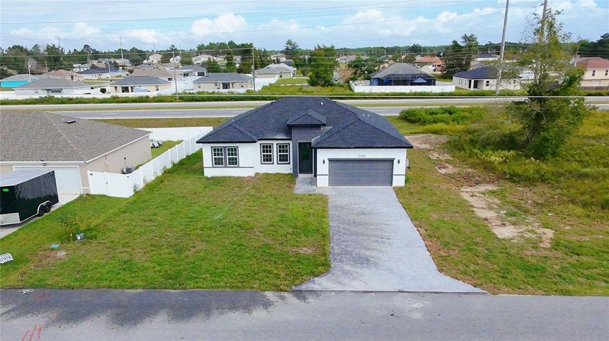 Welcome to your exquisite new home in Ocala.
Nestled on a 0.23-acre lot in the sought-after Unit 01 of Marion Oaks, this brand-new residence blends contemporary design with timeless elegance. From the moment you step through the impressive 8-foot front door, you’ll be greeted by an airy, open floor plan with soaring 9-foot ceilings, luxurious vinyl plank flooring, and premium finishes throughout.

The gourmet kitchen is a true showpiece — featuring stunning quartz countertops with a striking waterfall island, 42-inch custom wood cabinetry, and sleek stainless steel appliances. It’s designed for both functionality and style, making it the perfect centerpiece for entertaining family and friends.

Each bathroom showcases meticulous attention to detail, with floor-to-ceiling tile in the shower areas and modern fixtures that exude sophistication. The expansive primary suite offers a tranquil retreat, complete with a generous walk-in closet and a spa-inspired bathroom featuring dual vanities, a freestanding soaking tub, and a spacious glass-enclosed shower.

Experience the comfort, quality, and peace of mind of a brand-new home — all backed by the builder’s full home warranty. Discover refined living in the desirable Marion Oaks community and schedule your private showing today.