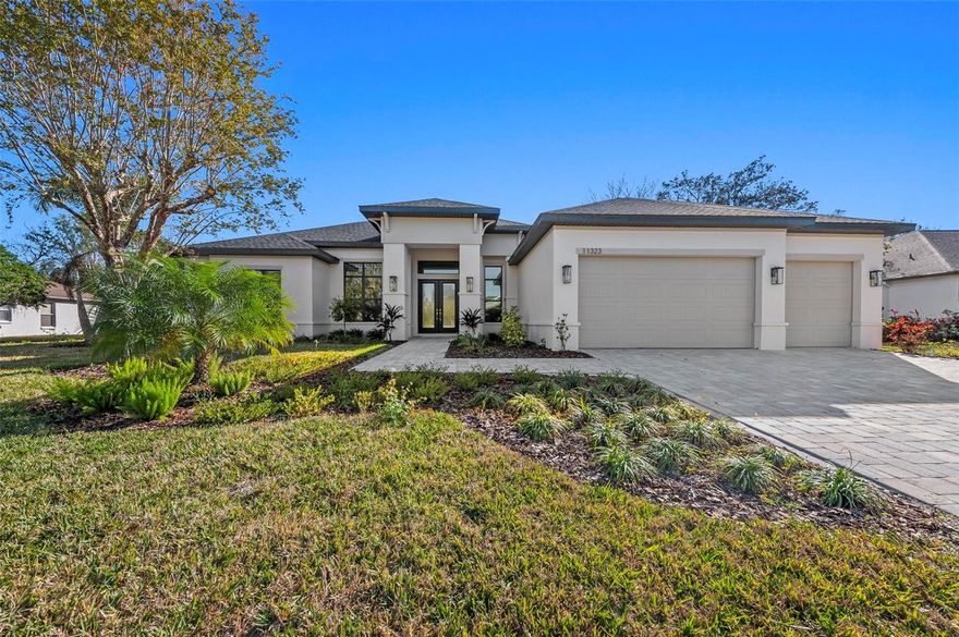 This custom-built Lee Wetherington home offers exceptional design and luxury in Lakewood Ranch's Summerfield Bluffs neighborhood. Situated on a beautiful private, wooded lot in this mature settled area, this home combines style, comfort, and high-end finishes throughout. The open-concept floor plan includes 4 bedrooms, 3 bathrooms and a spacious study. The 4th bedroom could also serve as a bonus room for a more casual living space and fun movie nights.  The 12-ft ceilings in the expansive living room and dining room create a sense of openness, while the pocketing sliding glass doors with a disappearing corner seamlessly connect the interior to the covered outdoor living, outdoor dining, summer kitchen, and heated saltwater pool—perfect for entertaining.
The chef's kitchen features soft-close cabinetry, Cambria quartz countertops, a large island with pendant lighting, GE Café Stainless Steel Appliances, and a huge hidden walk-in pantry. The luxurious primary suite includes two walk-in closets and a spa-like bathroom with a soaking tub, walk-in shower with two showering stations, and double vanity. The additional guest bedrooms offer privacy and comfort for guests. The bonus room is ideal for movie nights or a 4th bedroom.
Additional features include luxury vinyl flooring throughout the living areas, primary suite and bedroom 4, tile in all bathrooms and laundry room, carpet in bedroom 2 & 3, tray ceilings, washer and dryer, impact windows and doors throughout, and a 3-car garage with epoxy flooring. With a low HOA fee of only $96 per year, this home provides excellent value, along with a two-year Builders Warranty and ten-year structural warranty for added peace of mind. Don’t miss this unique opportunity to experience the Lee Wetherington difference in the heart of Lakewood Ranch—schedule your private showing today!