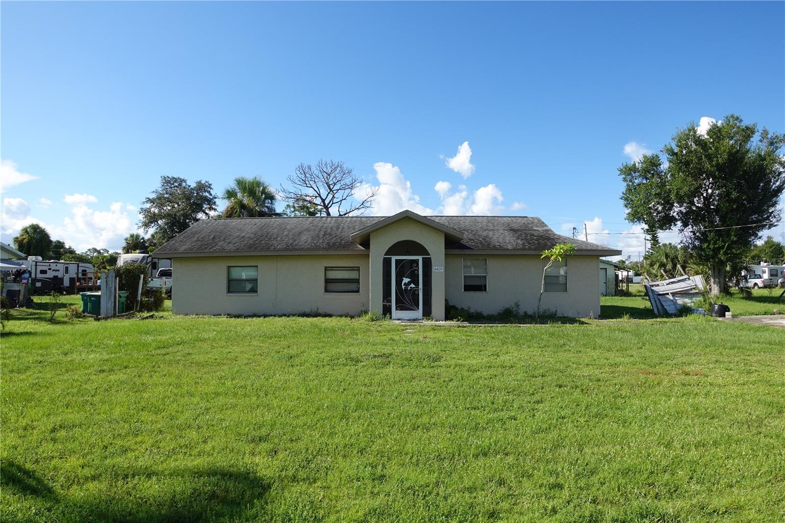 NO HOA-NO DEED RESTRICTIONS.
Spacious 4-Bedroom, 2-Bath Home on Nearly 0.4 Acres and Just 6 Miles to Englewood Beach.
Looking for a home with space, potential, and a prime location near the Gulf Coast? This 4-bedroom, 2-bathroom residence sits on a generous .39-acre lot with no HOA and no deed restrictions—giving you freedom to live as you wish.
Step inside through the screened entryway and double front doors into the open living room, complete with vaulted ceilings and a floor plan that connects seamlessly to the dining area and kitchen. The kitchen features vintage knotty pine cabinetry, a timeless detail that adds warmth and charm while offering plenty of storage.
Throughout the home, you’ll find porcelain plank and ceramic tile flooring for easy maintenance, with carpet in the spacious primary bedroom. The split layout provides flexibility for family, guests, or a home office.
Outside, the oversized lot offers endless possibilities—add a pool, create a garden retreat, or bring your boat, RV, and toys without restrictions.
Highlights: 4 bedrooms | 2 bathrooms | .39-acre lot, Vaulted ceilings and open layout, Vintage pine cabinetry in the kitchen, Mix of porcelain plank, ceramic tile, and carpet flooring, NO HOA, NO deed restrictions.
Only 6 miles to Englewood Beach and minutes to grocery stores, dining, and more. Whether you’re seeking a primary residence, seasonal retreat, or investment property, this home offers the perfect canvas to make it your own.
Bring your vision—and make this Gulf Coast property yours today!