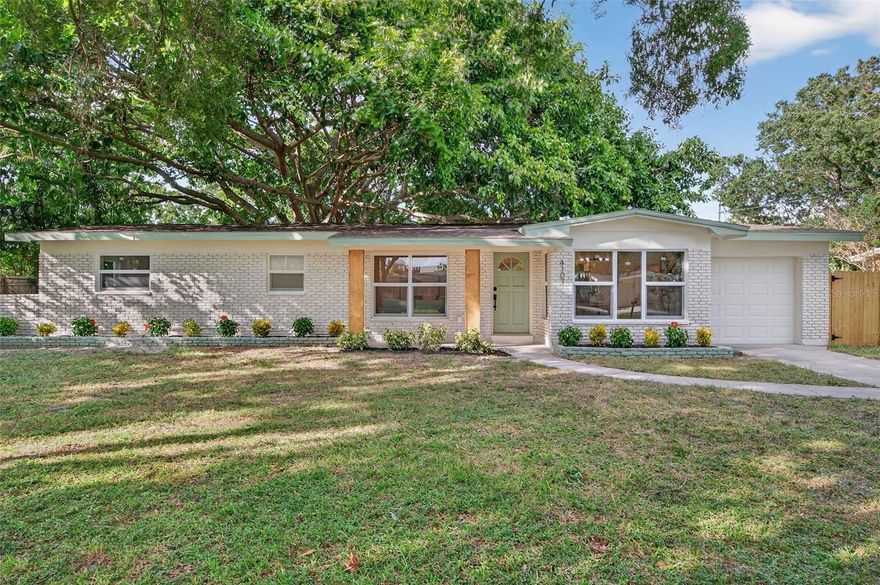 Welcome to your beautifully renovated South Tampa home! This stunning 3 bedroom, 2 bath home with a 1-Car Garage offers 1,488 square feet of thoughtfully designed living space. Major updates include 2025 Roof, 2025 HVAC system, 2025 hurricane-impact windows, updated electrical, and fully renovated kitchen and bathrooms. Every surface has been refreshed, from new luxury vinyl plank flooring and baseboards to interior doors, lighting, and hardware. The curb appeal impresses with wood pillars, green accents, a long driveway, and fresh landscaping. As you step inside, you’re immediately greeted by a bright, open-concept layout that seamlessly connects the living and dining areas, filled with natural light and neutral finishes. The living room features a built-in fireplace, creating a warm and inviting atmosphere. The home offers multiple dining options with a formal dining area, casual coffee table seating, and countertop seating in the kitchen, providing plenty of space for meals and gatherings. The designer kitchen features an L-shaped countertop with plenty of countertop space, quartz countertops, tile backsplash, stainless steel appliances, ample cabinetry, and a wet bar with wine cooler, perfect for hosting and everyday cooking. Step outside the sliding glass doors into the spacious, fully fenced backyard, featuring a brand-new tiled patio and a magnificent banyan tree. The primary suite is a serene escape with an ensuite bath featuring designer tile work, a frameless glass shower, and contemporary fixtures. Both guest bedrooms are oversized, offering flexibility for a home office or gym, and share a beautifully renovated full bath with a large vanity and modern finishes. The one-car garage is oversized, providing plenty of room for parking, storage, or a workspace. Located in the heart of South Tampa, this home offers the perfect balance of quiet residential living and unbeatable convenience. You’re just minutes from Bayshore Boulevard, the Selmon Expressway, Downtown Tampa, MacDill AFB, Hyde Park, and Downtown St. Pete, plus top-rated restaurants, shopping, and everyday essentials. This home is truly move-in ready and perfectly positioned in one of Tampa’s most desirable neighborhoods. Schedule your private showing today!