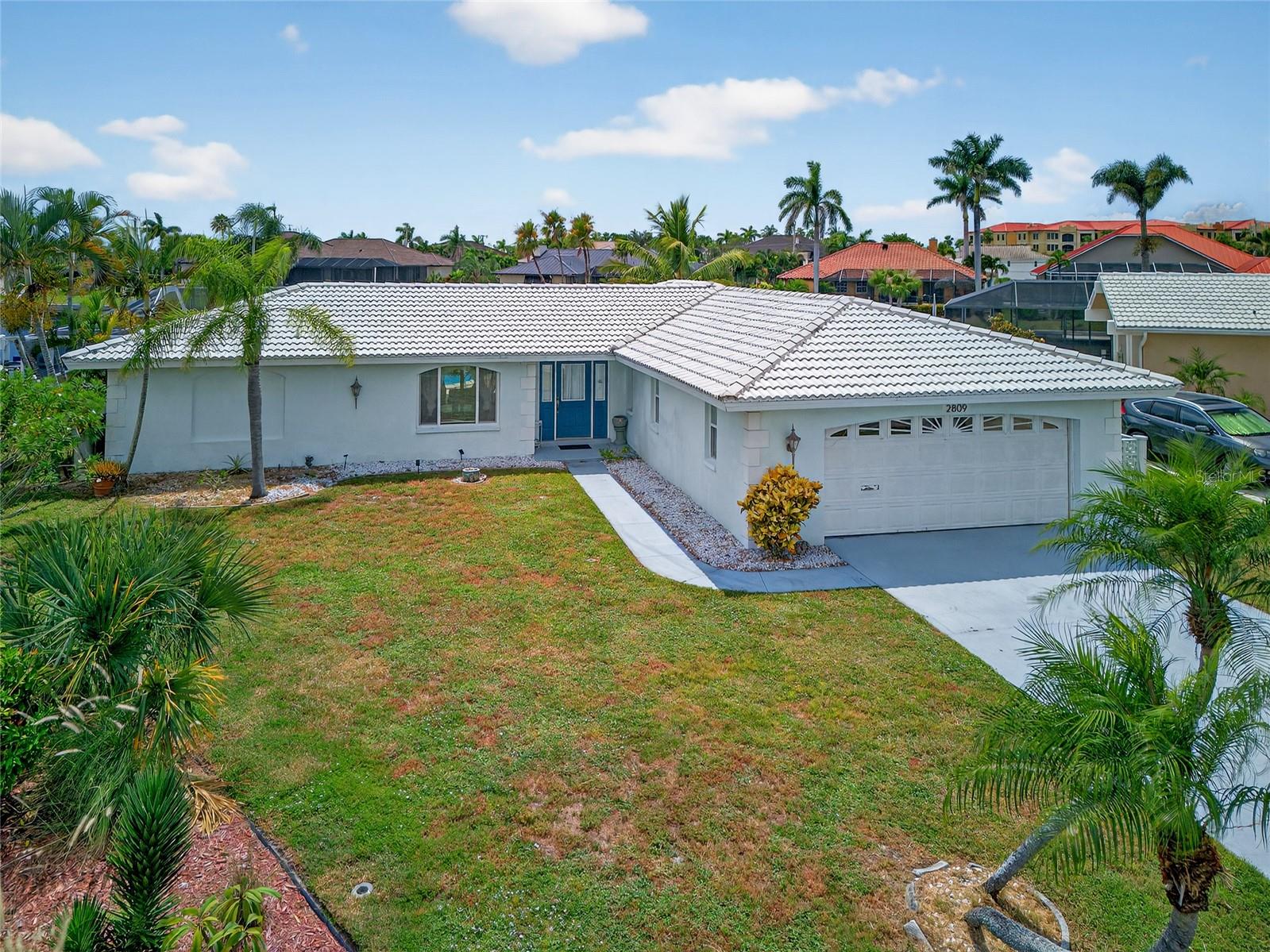 PUNTA GORDA ISLES! PRIME WATERFRONT LOCATION WITH QUICK SAILBOAT ACCESS TO CHARLOTTE HARBOR LEADING TO THE GULF! Oversized lot with 141’ of waterfrontage, concrete seawall, boat lift plus southwestern exposure to enjoy magnificent sunsets. Classic 2 bedroom plus den, 2 bath, 2-car garage pool home features an open floor plan, neutral décor, large slider to lanai in living room and ceramic tile flooring throughout. Spacious kitchen offers generous cabinetry, pass-thru window to lanai, center island with breakfast bar and dining area with slider to pool. Bonus room off kitchen and separate office add extra living space. Split bedroom plan provides plenty of privacy for all. Step outside to covered lanai, screened heated sparkling pool and large deck for soaking up the sun and enjoying the gorgeous intersecting canal views. New a/c installed in 2023. Nestled on a quiet street in a popular golf and boating community, this home is just minutes from the Yacht Club, Fishermen's Village, and the historic downtown area of Punta Gorda. Enjoy access to arts, community events, entertainment, world-class fishing, boating, fine dining, and beautiful parks. Don't miss the chance to make this home your new Florida retreat or permanent residence! Schedule your private showing today!