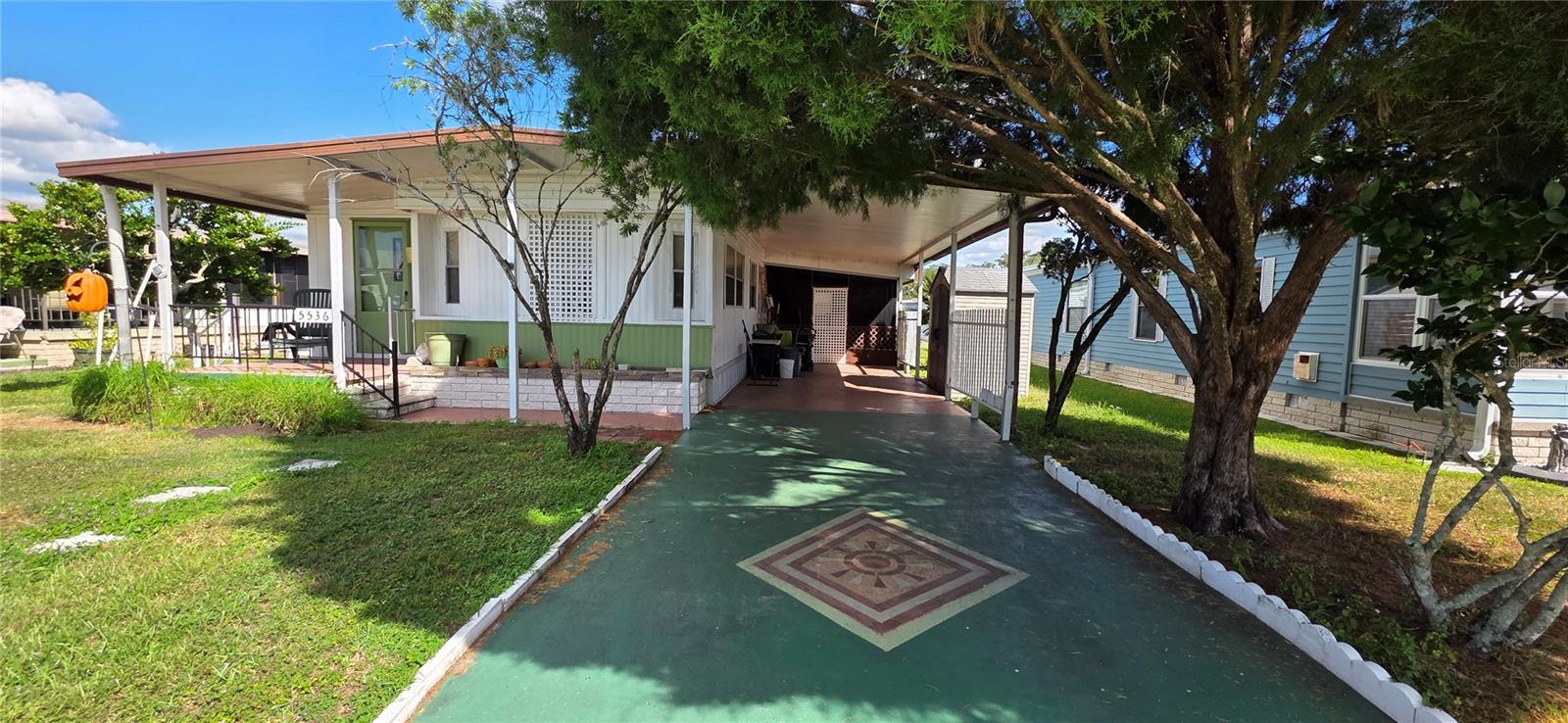 Restore this home to its former charm or replace it with your new dream home. This 14' x 60' singlewide features 2 bedrooms, 2 bathrooms, a long carport with space for two vehicles, and a covered front walkway leading to the side entry door. There's a generously sized, partially enclosed street-level screened porch with an attached laundry/utility room that includes a washer, dryer, and storage space. The spacious living room boasts a 7' x 12' addition and high ceilings. Open to the main living area is the centrally located eat-in kitchen, complete with a built-in hutch and dining space. A well-sized guest bedroom with a closet is situated near the full hall bathroom, which includes a garden tub. At the back of the home, you'll find the primary bedroom with its own add-on en-suite bathroom and walk-in shower. Though the home needs some TLC, it's situated in a fantastic location within Betmar Acres. The nice sized lot measuring (56'x86') could easily accommodate a new doublewide and is situated close to pools, clubhouses, and the memorial walkway in Betmar Acres—a vibrant, friendly 55+ community where you own your land & the low annual park dues of only $435 make it an appealing choice for those seeking an active & affordable Florida lifestyle. Betmar Acres offers a wide range of activities & amenities to keep you busy, including bingo, dances, indoor shuffleboard, two swimming pools, two hot tubs, organized monthly activities, three nine-hole golf courses, miniature golf, park library, horseshoes, pickleball, tennis, bocci ball, basketball court, gazebos, fenced pet play area & walking paths. This community has it all for your entertainment. Call today to schedule your private tour.