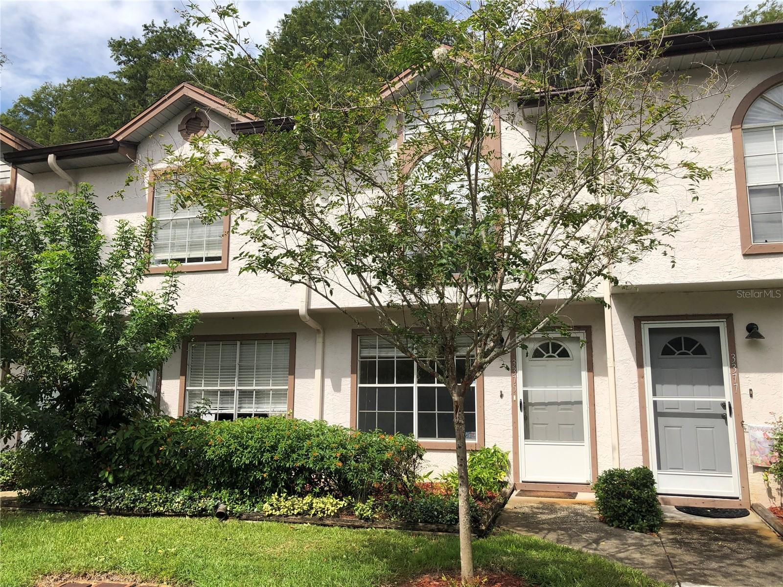 This lovely UNFURNISHED 2 story, 2 bedroom plus loft bedroom, 2.5 bath townhome features a wood burning fireplace and a great floor plan! Enjoy the living room with fireplace, dining room and kitchen with breakfast bar on the ground floor. There is a screened porch that overlooks the woods behind the unit right off the kitchen. Extra storage room out there too. The W/D hookups are back inside in a generous laundry closet off the kitchen. The kitchen has a smooth surface range, refrigerator with ice maker, dishwasher and disposal as well as lots of cabinet space and a closet pantry too! There is a half bath downstairs for guests. Upstairs you will find two good sized bedrooms. The master is 15 x 15 and has walk in closet and a second full wall of closet with extra shelves. The master bath and second full bath are both nicely appointed and there is a large loft area with a skylight that can serve as the 3rd bedroom or an office or gathering area. The community offers a large inground pool, dog walking areas, basketball, tennis courts, shuffleboard courts, bocce ball, playground! Nice recreation building that offers small gym, library & pool tables! With these activities you won't want to miss this amazing resort-like condo living & Live a maintenance FREE lifestyle. Great location as you have easy access to downtown Tarpon Springs (north) or downtown Palm Harbor, Dunedin and Clearwater (south) Plenty of quaint stores and restaurants in either direction! Minutes from Honeymoon Island & other Gulf beaches! Call to schedule your private showing today!