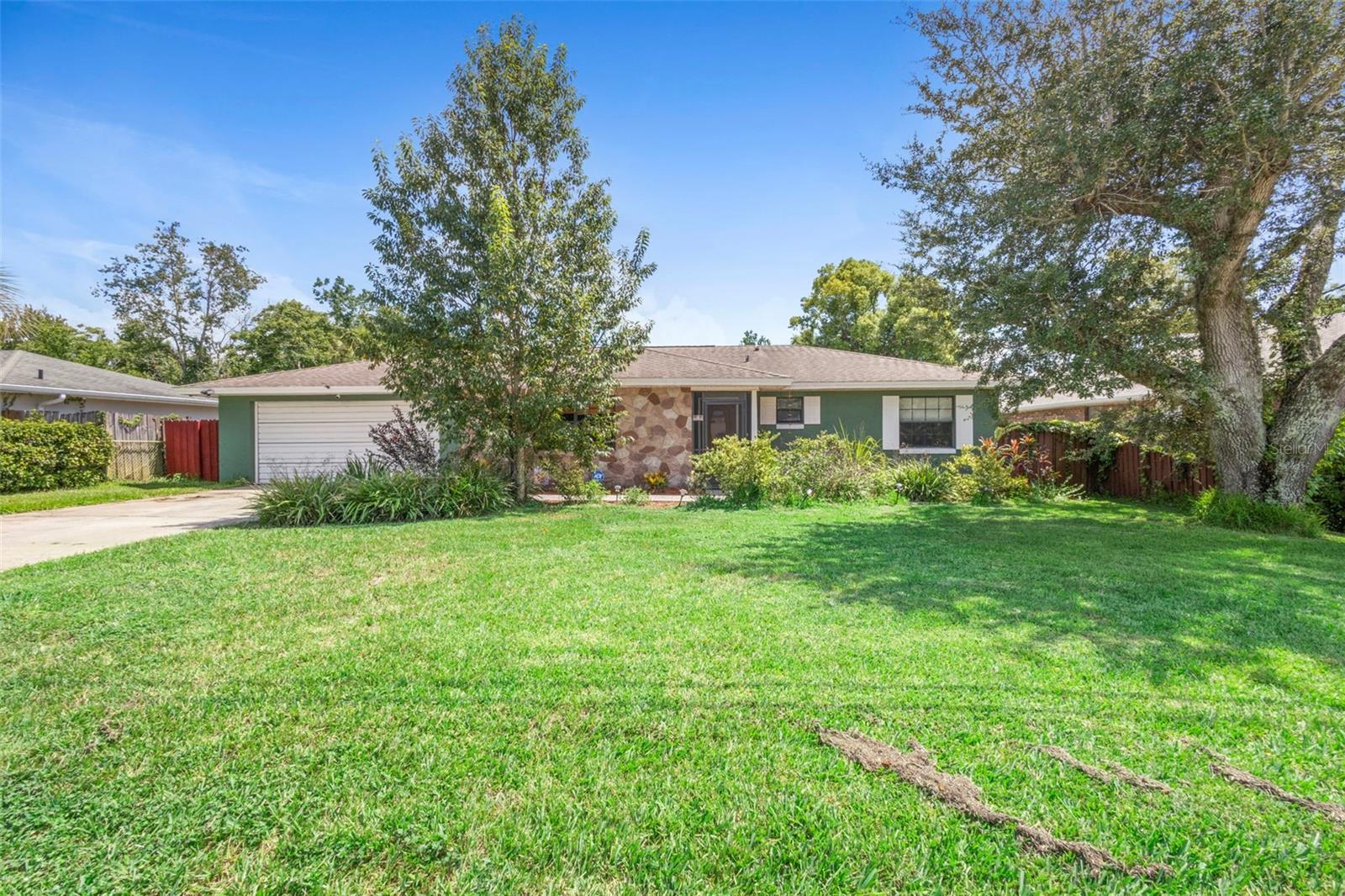 Move-In Ready Home in Desirable Deltona Location!
This beautifully maintained block/stucco home in the sought-after Country Club area of Deltona offers a fantastic combination of comfort and convenience. Close to I-4, 1792, movie theater, shopping, dining, and the Amazon fulfillment center, this location is ideal.
Upon arrival, you'll admire the lush landscaping with a full irrigation system and a fully fenced backyard, perfect for privacy and outdoor activities. The inviting foyer opens into a versatile formal living room that can suit your lifestyle needs.
This home features an open floor plan with recent updates, including a remodeled kitchen with brand-name KitchenAid stainless steel appliances, wood cabinets, and elegant marble countertops. The roof was replaced with architectural shingles in 2018, and the HVAC system (15.5 SEER Trane) was updated in 2015. Freshly painted interior and exterior, updated bathrooms, and oversized neutral travertine tile throughout main living areas (carpet in bedrooms) add to the move-in condition.
Additional highlights include a 2-car attached 22x28 garage with a workspace and laundry, a spacious 12x30 screened lanai with ceramic tile for outdoor living and entertaining, newer hot water heater, a septic pumped in 2024, and a well-designed layout with generous room sizes.
This proud-to-owner home is ready for new owners—don’t miss your opportunity! Schedule your showing today.