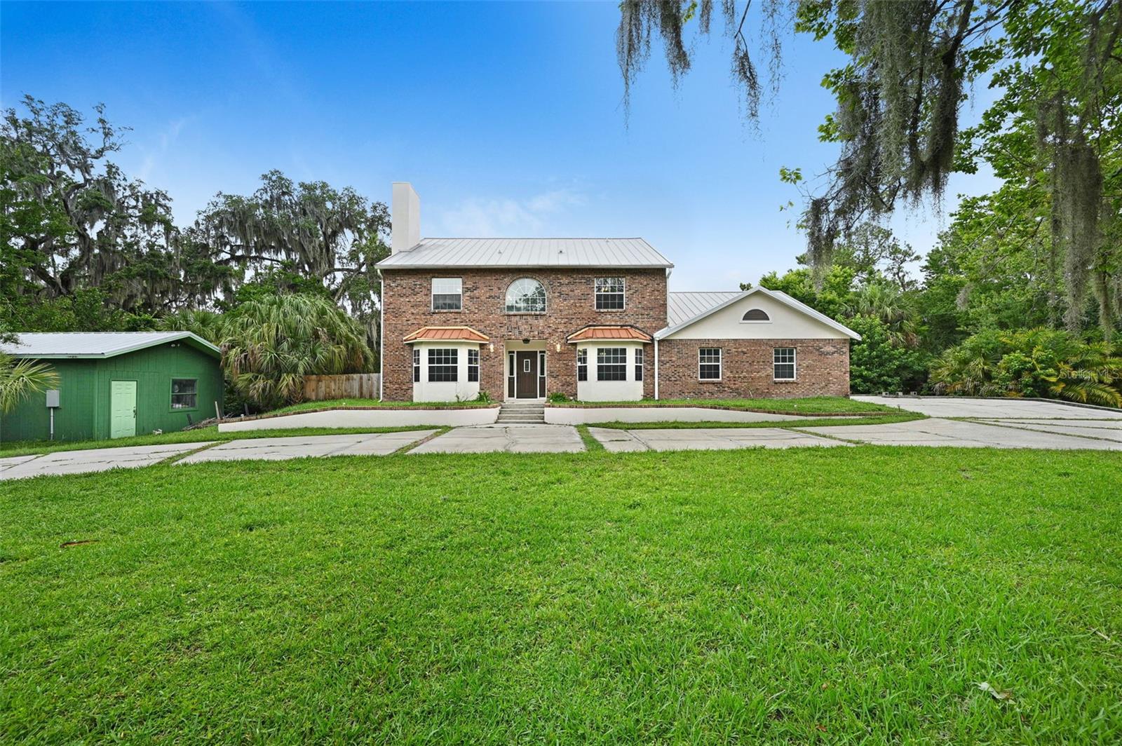 Surrounded by nature on 2.5 acres, this 1994-built, 3,006?sq?ft home features 4 bedrooms, 3 full bathrooms, and a bonus room above the 3-car garage—perfect as an extra bedroom, home office or play room. The standing seam metal roof is built to last, and the outdoor shed includes fresh siding, paint, and electricity. Step outside to enjoy the oversized pool, tranquil pond, and open yard—all in a peaceful, private setting. Don't miss out on a one-of-a-kind spot that blends practicality with laid-back Florida charm in a truly special location.