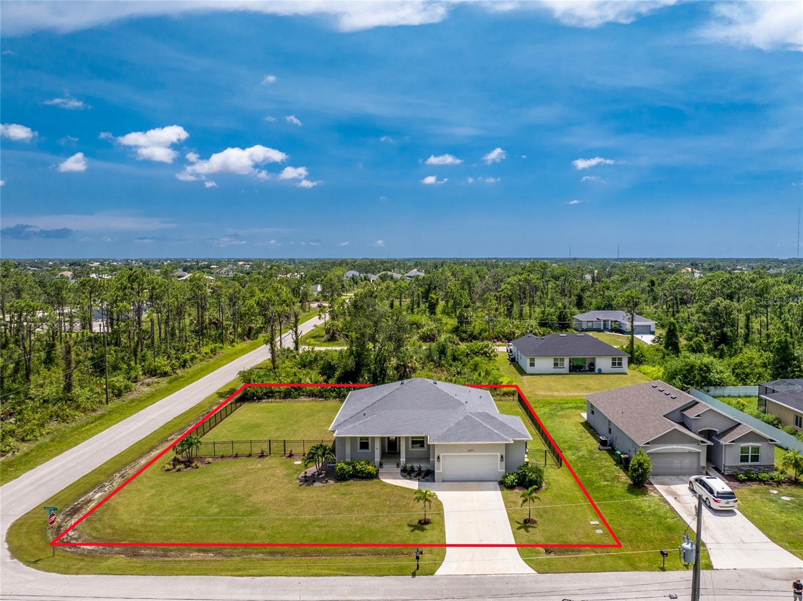 Be ready to be impressed by this 2022-built 3 bedroom plus den, 2 bathroom home with an oversized 2.5 car garage in the desirable South Gulf Cove community. Located on a large corner lot in a deed-restricted but HOA-optional neighborhood, you can choose to join the association and enjoy access to parks, a playground, clubhouse, and a calendar full of community events. From the moment you arrive, the mature landscaping and inviting front entry set the tone for the thoughtful upgrades throughout. Inside, you’ll find consistent wood-look tile flooring, tray ceilings in the entry, great room, and dining area, upgraded light fixtures, and 8-foot doors that add to the open and welcoming feel. The home was built higher than current building requirements for added peace of mind and includes impact windows and doors throughout. The kitchen features white shaker cabinets, granite countertops, a large center island with beadboard accents, and a reach-in pantry. Dual sliding glass doors in both the kitchen and great room allow for fresh breezes and seamless indoor-outdoor living. The ensuite primary bedroom offers a relaxing retreat with tray ceiling, sliding glass doors to the lanai, both a walk-in and reach-in closet, a dual sink vanity, and a fully tiled walk-in shower with built-in bench. Guest bedrooms are generously sized with custom built-ins in the closets, and the guest bath features a sleek, frameless glass partially enclosed tiled shower. Double doors lead to the den, ideal as an office, exercise space, or fourth bedroom. The interior laundry room has a utility sink and shelving. Some furniture is optional, and outside, there’s plenty of room to park your boat or RV. The spacious screened lanai overlooks a fenced backyard perfect for pets or a future pool. The oversized garage features epoxy flooring, storage shelving, bike and surfboard racks. South Gulf Cove is just 20 minutes from Boca Grande and Englewood beaches and close to shopping, dining, golf, spring training stadiums, and medical facilities. Residents enjoy easy access to a public boat ramp with direct routes to Charlotte Harbor, perfect for waterfront dining or sandbar adventures. If you're searching for a modern home with high-end finishes, peace of mind, and a true Florida lifestyle, 14377 Overlook Avenue is ready to welcome you. Schedule your private showing today.