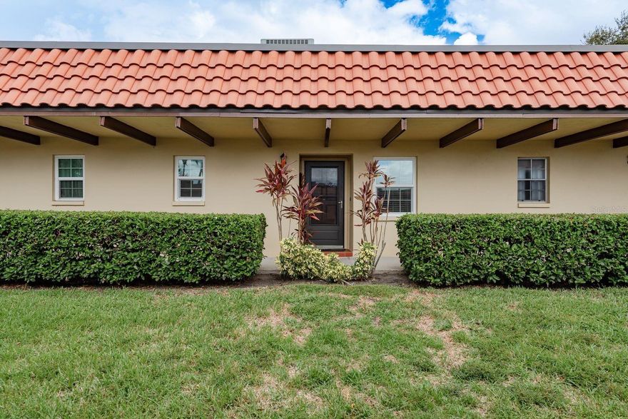 One or more photo(s) has been virtually staged. Welcome to this beautifully maintained 1-bedroom, 1-bath villa style condo located in the sought-after Pinehurst Village, a manicured 55+ community offering a maintenance-free lifestyle in the heart of Dunedin. Tucked away at the end of a quiet cul-de-sac, this unit provides both privacy and tranquility, with a serene backyard green space view from the enclosed bonus room. Inside, you'll find numerous recent updates including luxury vinyl flooring throughout, hurricane-impact windows and sliding door, new countertops and appliances, a recently installed hot water heater, a renovated bathroom, upgraded electrical panel, newer fans/lighting, and kitchen sink/faucet. The roof was replaced in 2024, and the in-unit laundry closet with washer and dryer adds extra convenience. The HVAC system is maintained bi-annually. Freshly painted interior! The attic is easily accessible for storage and has recent added insulation! Your assigned covered parking spot is located directly in front of the unit, making access easy and hassle-free. Community amenities include a heated pool, clubhouse, shuffleboard courts, and an outdoor grilling area with picnic tables, ideal for gatherings and socializing with neighbors. This prime location places you just minutes from downtown Dunedin, the Dunedin Marina, Community Center, Dunedin Fine Arts Center (DFAC), TD Ballpark featuring Toronto Blue Jays Spring Training, and the scenic Dunedin Causeway leading to Honeymoon Island State Park. Whether you're seeking a seasonal retreat or a full-time Florida residence, this move-in ready villa offers the best of easy living and coastal charm.