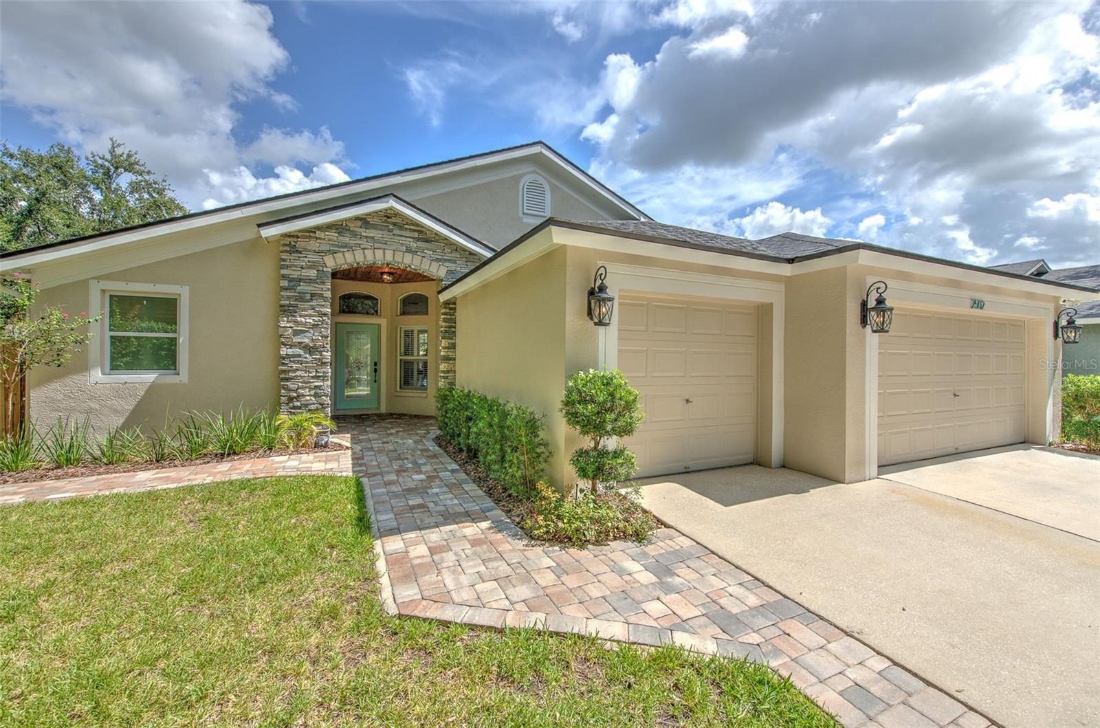 Beautifully renovated 4 bedroom, 3 full bathroom, split floor plan pool home with 3 car garage located in Bloomingdale. This home offers the feel of new construction without the new construction price in an established, sought-after neighborhood with no CCD fees. The experience starts on the covered front porch offering space to decorate for the seasons, canopied by gorgeous wood outdoor ceilings. From the heart of the home which is a fully renovated kitchen with quartz counters and floor to ceiling cabinetry, to the built-in buffet/bar. You can use this built-in as a stylish wine and coffee station for entertaining, a snack bar for casual family nights, or a chic serving area for dinner parties and holiday gatherings. Next, you will notice the spacious great room, where a large picture window floods the rooms and upgraded wood look tile floors with natural light. The custom built-in electric fireplace and shelving add warmth and style, while the tall sliding glass doors offer seamless flow to the expansive pool area. The primary suite offers a spa-inspired bathroom with dual shower heads plus a rain shower, and a luxurious, freestanding soaking tub, where high-end finishes and thoughtful touches create a sense of calm and comfort. Two secondary bedrooms and a full bathroom are located at the front of the home, while a private guest ensuite in the rear includes a third full bathroom, conveniently featuring a door to the pool area. Step out back and you'll feel like you've entered into your own private resort. The oversized pool area, outdoor wood ceilings, stone pavers, re-screened pool cage, generously-sized entertainment area behind the home, and pet-friendly turf wrapping around the East side of the home combine to create a relaxing outdoor oasis. With updates such as a 2019 roof, newer electric water heater, newer water softener, new pool pump, and custom hurricane shutters, this home boasts peace of mind and polished living. Bloomingdale Cove offers a private park including a basketball court and picnic areas and is located very close to two Publix Supermarkets, the rumor of a new Whole Foods, Sprouts, Starbucks, and two breweries, and is located just 4-5 miles from Target, 301, and I75.