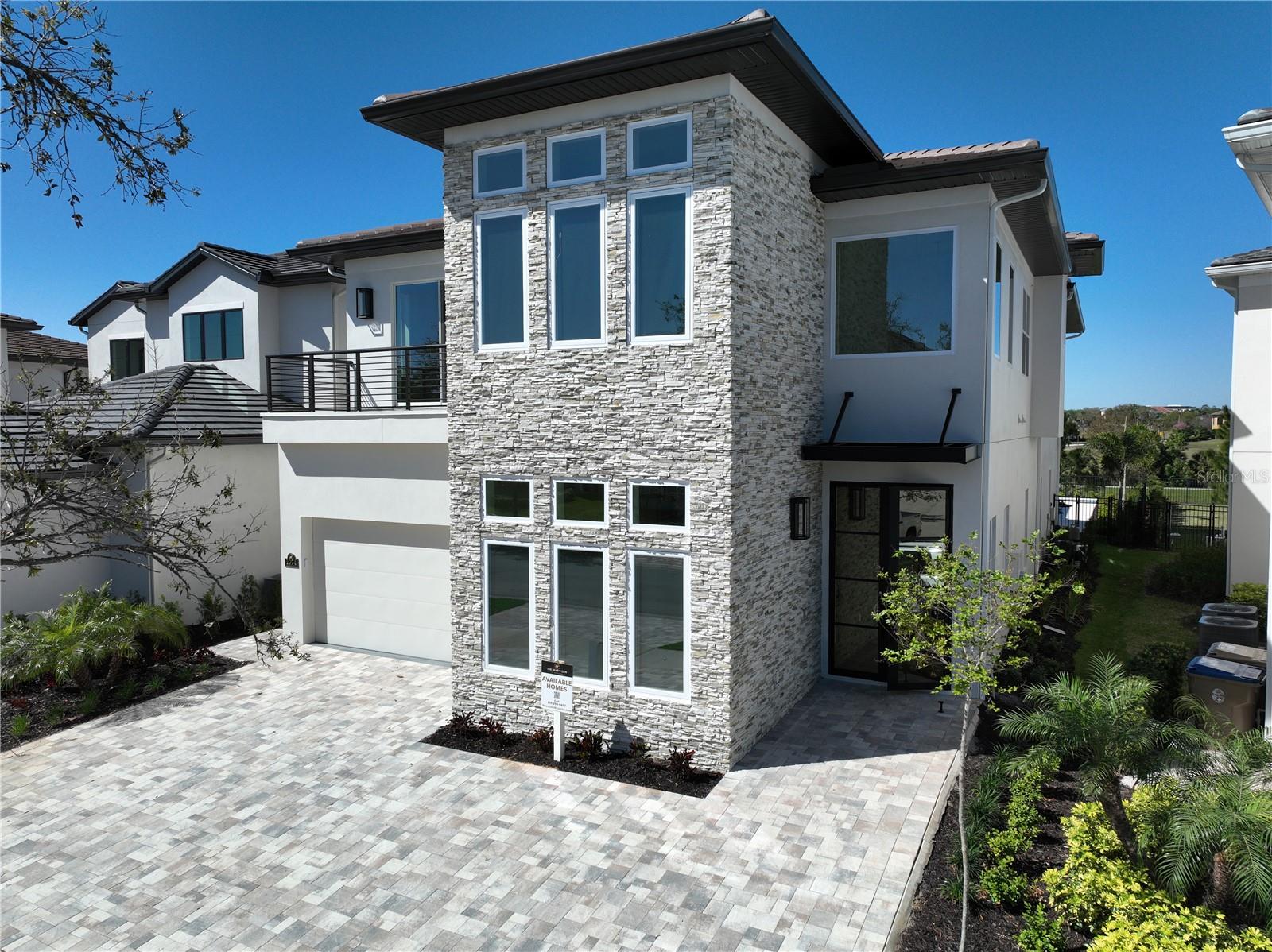 Beautiful New Home just completed - located on the Nicklaus golf course in Reunion. This spacious home is on an oversized homesite behind the gates of the Bear's Den and features 7 bedrooms with 7 full baths and 2 half baths, game rooms, movie theater, and bar. Wander outside to the magnificent pool and spa, 2 covered patio areas for seating and a plenty of space for those who love the sun. Gourmet Summer Kitchen is great for barbeques with friends and family. Amazing views from the living room, dining room, and multiple balconies to enjoy your morning coffee. Whether you want to use your home as primary for family and friends or a luxury rental property, this home offers many options. Bring your designer to furnish the home the way you want with the latest designs. The Interior architectural details and finishes stand out on this home. Two first floor suites for guests or extended family. Spacious suites feature en-suites attached bathrooms on each level. Beautiful porcelain flooring in all common areas on the first level, wood on the 2nd floor stairs and hallway. Gourmet kitchen, two islands with quartz countertops, Thermador appliances and a built-in pantry and plenty of storage throughout the home. The second Floor includes a game room, movie theater for entertaining, 5 bedroom en-suites, including a second primary suite with private balcony. Watch the Sunsets on the balcony or relax in the spa in the evening. Reunion Resort is a World Class destination just 10 minutes away from Walt Disney World with access to 3 signature golf courses, 6 tennis courts, pickle ball courts, a water park with lazy river, as well as 6 restaurants within the community. The impressive clubhouse at Bears Den features a restaurant, pro shop, men's and women's locker rooms. Call today to schedule a private showing. This is a Jack Nicklaus Licensed community with Reunion Gold or Platinum Membership available.