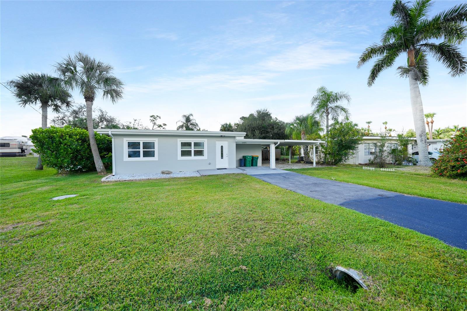 One or more photo(s) has been virtually staged. OWNER FINANCING AVAILABLE WITH 20% DOWN - TERMS NEGOTIABLE - Discover Your New Home in Sunny Port Charlotte! Completely renovated and truly move-in ready, this beautifully updated 3-bedroom, 2-bath home with a lighted carport offers 1,382 sq. ft. of air-conditioned living space that seamlessly blends modern comfort with timeless Florida charm. Originally built in 1956, the home has undergone a comprehensive remodel featuring all-new drywall, fresh interior and exterior paint, recessed lighting, tile flooring throughout, and energy-efficient windows. Electrical upgrades include the removal of outdated cloth wiring, replacement of switches, outlets, and hardware, plus new smoke detectors—ensuring safe and reliable power for years to come. Set on a spacious 9,000 sq. ft. lot, the property boasts a fully fenced backyard with an expansive concrete patio, a cozy stone firepit, and two large storage sheds—perfect for hobbies, tools, or outdoor gear. Step inside to a split floor plan where the front living room flows effortlessly into the updated kitchen. This stunning modern kitchen showcases sleek quartz countertops, crisp white shaker cabinetry, and stainless-steel appliances, including a smooth-top range and built-in microwave. Recessed lighting illuminates the space, while soft aqua accent walls add a refreshing coastal vibe. With ample storage, a functional layout, and elegant finishes throughout, this kitchen perfectly balances style and practicality—ideal for both everyday living and entertaining. Just off the kitchen, the dining room offers direct access to the backyard patio, creating a seamless connection for indoor-outdoor dining and weekend gatherings. Conveniently located nearby, the inside laundry/utility room adds extra functionality and storage, keeping household chores organized and out of sight. The primary suite includes a bonus room with a spacious double-door closet and a beautifully remodeled ensuite bath featuring a granite-topped vanity with a vessel sink, plus a walk-in shower with large tiles, a pebble floor, and an overhead rainfall shower—a true touch of modern luxury. The guest bedrooms are equally inviting, one offering a walk-in closet, and both conveniently located near the updated second full bath, which features a new single-sink vanity and a walk-in shower with rectangular gray tiles, vertical accent strips, and a pebble stone floor. The expansive backyard provides plenty of room to grow—perfect for adding a lanai, pool, or outdoor kitchen in the future. Every detail of this home reflects thoughtful craftsmanship and quality upgrades, making it a true move-in-ready gem. With convenient access to US-41, I-75, shopping, dining, medical facilities, and Gulf Coast beaches, this home offers the perfect blend of comfort, convenience, and coastal living.
**PLEASE ENJOY THE 3D INTERACTIVE VIRTUAL TOUR ASSOCIATED WITH THIS LISTING**