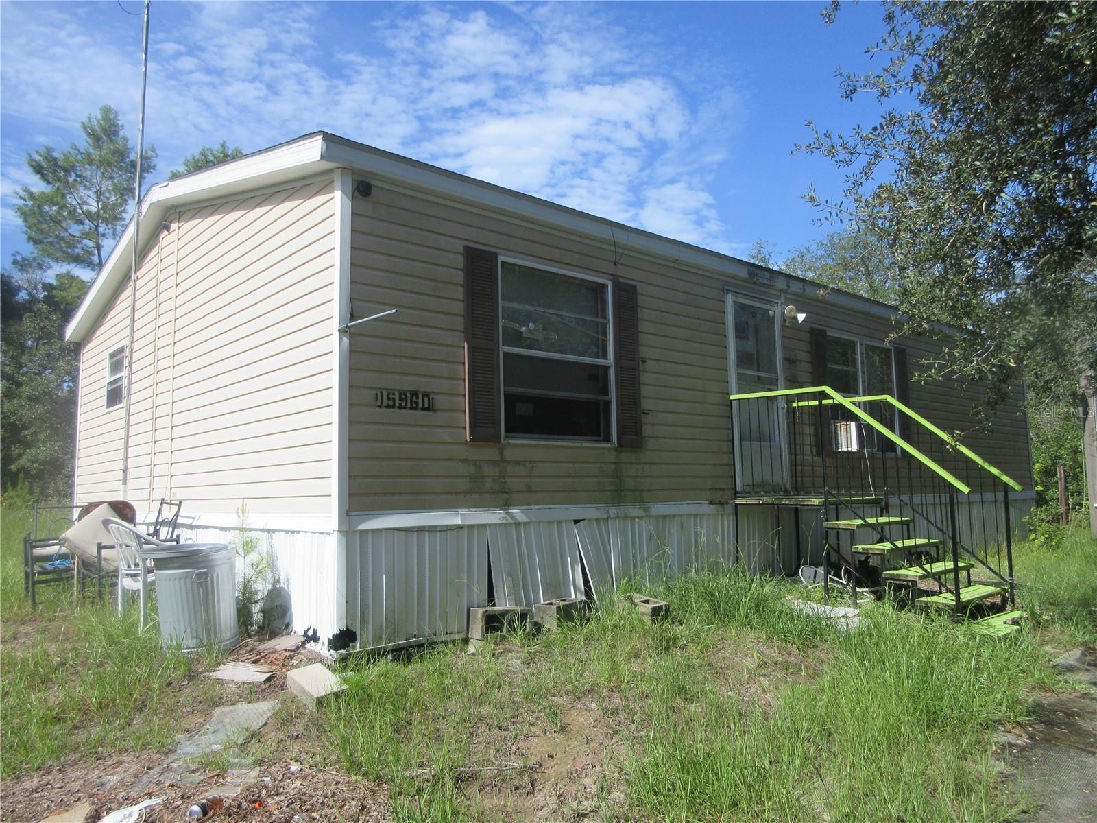 The Ocala Nathional Forest Trails are just 160 ft away from this home for some Endless Outdoor Fun and Adventure! If you want to get away from city life and live on the literal edge of the frontier at an affordable price, THIS IS IT! Come see this 2/2 2005 Nobility Doublewide Home Handyman Special! The size of the home is 24x40. The home features a walk-in closet, shower in master bath and a tub in the guest bath. The home has its own septic tank, power pole and 12x28 utility building to keep your atv, dirtbikes, hunting and fishing gear. The home sits on two cleared corner lots totaling .45 acre in size and just 160 feet away from the Ocala National Forest. The home is connected to the adjoining properties well which is also for sale. Th adjoing property has a dilapidated doublewide mobile home sitting on two lots that actually touch and adjoin the Ocala National Forest. It's address is 15990 NE 231st ST. Fort McCoy, FLA. 32134, being parcel number 0052-001-0096. The asking price on 15990 is also $80,000. In regards to 15960, what updates are needed? If you purchase just 15960, you will need a well because the two properties share the well. 15960 also needs an electrical and central A/C repair. The A/C blows but not cold. So with a few repairs and a well, you will have a fantastic get away and hunting camp right on the edge of the frontier. A great buy at just $80,000, HURRY!