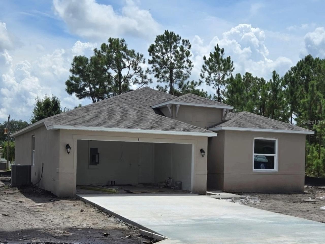 Under Construction. This brand-new construction home offers the perfect blend of elegance, comfort, and modern convenience. Designed with durable block and stucco construction, this open floor plan features 4 bedrooms, 2 baths, and 1,801 sq. ft. of thoughtfully designed living space. Soaring 9'4" ceilings throughout the home create an airy, spacious feel. Enjoy the Florida outdoors with a 6’ x12’ covered porch. The stylish 36” North Point Hattaras white cabinets are beautifully complemented by Granite Valle Nevado "gray" countertops, adding a touch of sophistication to the kitchen. Luxury vinyl plank flooring flows seamlessly throughout the entire home, offering both durability and style. A stainless-steel appliance package is INCLUDED, featuring a 24.3 cubic foot side-by-side refrigerator with a built-in ice maker, a 30” freestanding smooth-top electric range, a 1.6 cubic foot over-the-range microwave, and a dishwasher - everything you need for a fully equipped kitchen! For added peace of mind, your purchase includes a 2-10 Builder’s Warranty. NOTE: Photos are for example purposes only