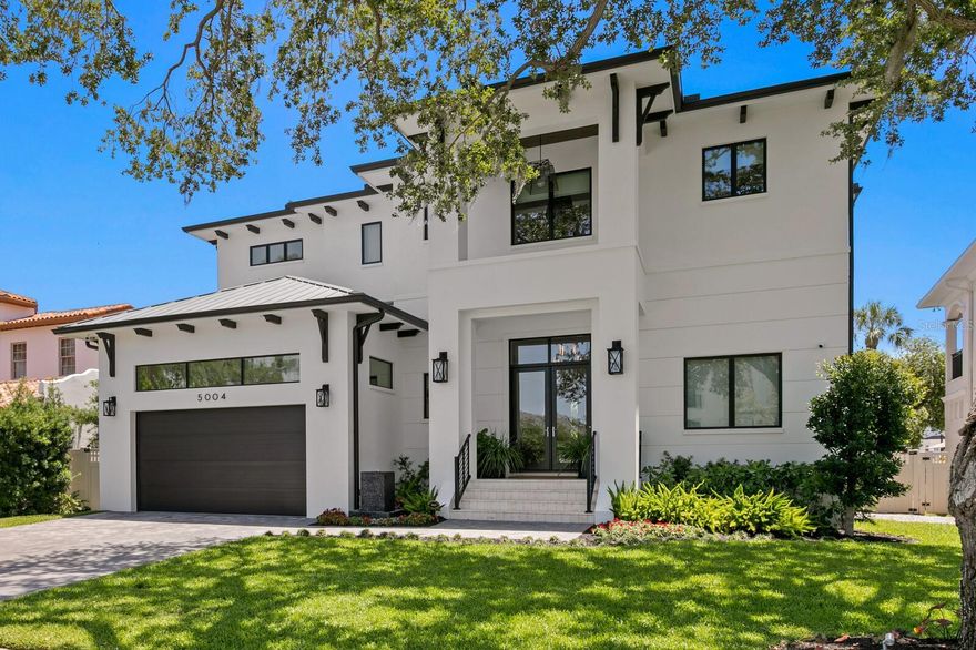 Welcome to this Beach Park waterfront masterpiece where timeless elegance meets modern luxury.  This exceptional estate offers 5 bedrooms, 6.5 baths and nearly 5,900 square feet of thoughtfully designed living space, perfectly positioned to capture the essence of refined Florida living.  Step outside to your private resort, where a heated pool with spa and sun shelf invites endless days of relaxation beneath the sun.  A spacious covered lanai, accented with rich wood ceiling details, features a fully equipped summer kitchen and a natural gas fireplace - an idyllic setting for al fresco dining and effortless outdoor entertaining.  Just beyond the pool area features composite decking leading to the covered boat dock, equipped with a 16,000 lb boat lift and separate double jet ski lift.  Enjoy your outdoor beverage by the natural gas fire table creating the perfect ambience as the sun sets over the water.  Inside, an open concept layout featuring 12' soaring ceilings seamlessly connects the chef's kitchen, featuring Sub-Zero and Wolf appliances, centered around a grand island, with the living and dining areas, all bathed in natural light.  Just off the kitchen, a spacious prep kitchen offers ample counter space and storage for the most discerning host.  For the wine connoisseur, a  climate controlled wine cellar custom built by Genuwine Cellars holds up to 1,400 bottles, a stunning centerpiece designed for showcasing and collecting.  Each of the 5 en-suite bedrooms is a private retreat, offering luxurious finishes and spa like baths.  The primary suite is a sanctuary unto itself, with a serene sitting area both indoors and on a private balcony overlooking the water.  The spa-inspired primary bath features a soaking tub, a generously sized walk in shower with multiple shower heads and dual walk in closets, blending tranquility with sophisticated functionality.  An elevator adds ease and elegance to daily living, while every corner of this home has been crafted with attention to detail and an eye for quality.   This South Tampa home is just minutes away from TPA airport, Hyde Park and downtown Tampa.  This is more than a residence-it’s a lifestyle of waterfront luxury, where everyday feels like a getaway!