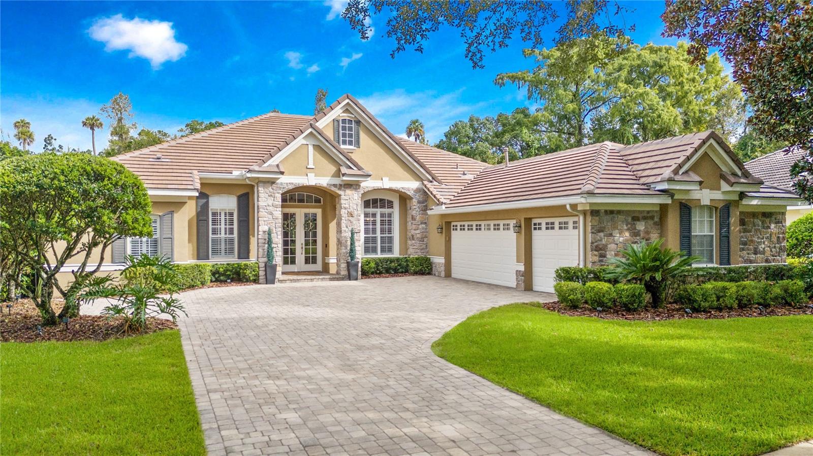 Welcome to this beautifully maintained home in the guard-gated community of Alaqua Lakes! This elegant one-level residence offers 4 spacious bedrooms, 3.5 baths and a dedicated office or potential den with custom built-in cabinetry. Designed for both entertaining and everyday comfort, this home features a formal living room and dining room perfect for gatherings of friends and family. The gourmet kitchen features granite countertops, a spacious island, gas cooktop, solid wood cabinetry and stainless steel appliances—all flowing naturally into the inviting family room with built-in shelving/cabinets and a gas fireplace. High ceilings, crown molding and abundant natural lighting create an open, airy ambiance throughout the home. The primary suite is a serene retreat with walk-in closets, a separate sitting area and a spa-like bathroom with granite countertops, built-in vanity area, solid wood cabinetry, garden bath and adjacent shower. A desirable 3-way split-plan ensures utmost privacy for family or guests. Enjoy outdoor Florida living with a covered lanai overlooking the sparkling pool with a NEWER pool screen enclosure and a private backyard with conservation views perfect for relaxation and entertaining! Large, private backyard with room to add on if you so desire. This home has been meticulously maintained with recent updates including a NEWER TILE ROOF (2023), NEWER HVAC systems (2019) and NEWER TANKLESS water heater (2019) for peace of mind. Whether you’re a growing family or seeking a refined downsizing opportunity, this Alaqua Lakes home delivers a rare combination of style, function and privacy in one of Central Florida’s most sought-after communities. Alaqua Lakes is set within a premier golf course community where residents enjoy world-class amenities including clay tennis courts, a resort-style pool, playground and sports field, a 24-hour guard-gated entrance and enhanced community security. Located near Central Florida’s best attractions, upscale shopping and dining, major highways, and international airports this exceptional home delivers a rare combination of luxury, privacy, and lifestyle.