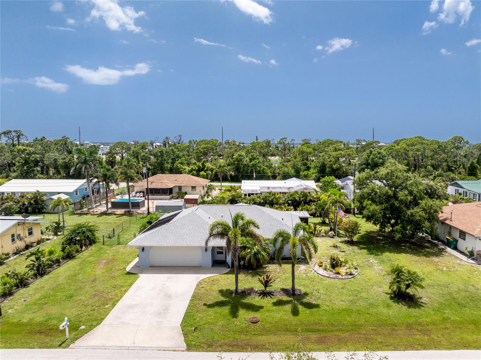 JUST ONE BLOCK FROM THE COMMUNITY BOAT RAMP, THEN EASY ACCESS TO LEMON BAY AND THE GULF! NEW DIMENSIONAL SHINGLE ROOF ON HOUSE AND SHED IN 2023, NEW AC IN 2022, AND IMPACT WINDOWS IN 2017! No pesky deed restrictions or mandatory HOA fees! NOT IN A DESIGNATED FLOOD ZONE so your lender will not require you to have flood insurance. There was NO WATER damage here from either Hurricanes Helene or Milton. This very functional floor plan will surely meet your needs, with a combo living/dining area open through to the Family room. (currently used as a Formal dining area) The kitchen has plenty of cabinetry and countertops, and there's even room for a small dinette table, if you should so desire. Popular split plan has the Primary Bedroom on one side of the house, and the Guest Bedroom opposite. The Primary bedroom has a HUGE WALK IN CLOSET, ceiling fan, and sliding glass doors to the Lanai. The Primary Bath features a shower w/door. The Guest bedroom is good sized, and has a full length wall closet and ceiling fan, and the Guest Bedroom has a combo tub/shower. The tiled flooring laid on a diagonal throughout the house makes for easy maintenance. The two car garage houses the washer/dryer/utility tub. The screened lanai will be your favorite place to hang out, when the weather is cooler. Chain link fence surrounds the backyard and the SWIMMING POOL. Small garden shed for extra storage. FURNISHINGS NEGOTIABLE.