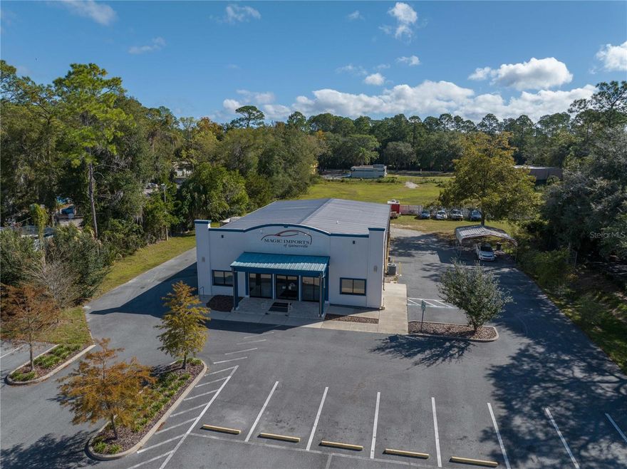 Established car lot and PRIME location on N Main Street in Gainesville, Florida with a state of the art construction built in June of 2017 on 3.09 acres. This property is featuring a beautiful entry with high ceilings in the showroom, 5 offices, printing area and storage room. The auto service area has 6 bays, 3 on each side with 4 new lifts, new air compressor, air hoses running above head. Two hour fire wall barrier between shop and offices. Wireless remote access cameras recording 24/7 and alarm system. In addition a service area which includes a waiting area, TV, refrigerator for water and coffee machine for customers. It is ready to sell and service from day one.  A 2 acres land cleared in the back to store vehicles and/or building extra space. A Total of 4,290 sq ft. This property is also for lease for $15,000/month NNN