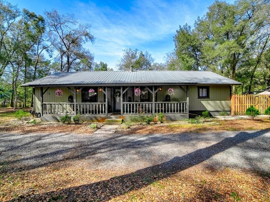 Custom-built in 1994, this charming country-style home sits on a quiet cul-de-sac in DeLand, just 4.3 miles from Stetson University and 4.6 miles from downtown DeLand. Situated on nearly one acre, the 3-bedroom, 2-bath home offers almost 1,600 square feet of open living space with wood-beamed ceilings, a wood-burning fireplace, and custom brick accents from a historic DeLand building. The home features a top-of-the-line metal roof, extra wall insulation, new luxury vinyl plank flooring, and freshly painted interiors. The HVAC system, stainless steel appliances, hot water heater, and water softener. 

The property is fully fenced and cross-fenced with a brand new private electronic entrance, and the pool area is separately enclosed for added safety and privacy. Outdoor amenities include custom landscaping, a large country-style front porch, in-ground pool, wood deck overlooking the pool, outdoor bar area, fire pit, oversized two-car garage/workshop with 240 electric, two additional covered bays, and a gravel driveway extending from the front entrance to the back of the property.