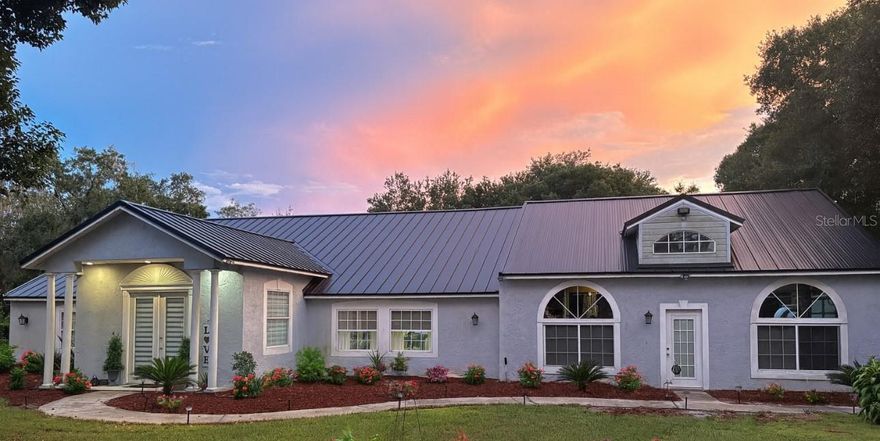 One of a kind fully fenced one-acre estate is just minutes from Lake Nona and all Central Florida has to offer. Ideal for car enthusiasts and hobbyist this home features three garages with six bays, a breezeway workspace for additional vehicles, 50-amp upgraded electric service, compressor lines, and a full bath in one garage that can be utilized as an in-law suite or additional bedroom. Inside, enjoy 3 Bedrooms with family room, dinnin groom and family room, with features such high tin ceilings, crown molding,new tile floors, a built-in wet bar, movie/bonus room pre-wired for surround sound, formal dining, and a spacious kitchen with solid wood cabinets and premium appliances.The private master suite offers sliding doors to a seating area, large walk-in closet, and stylish ensuite bath. The lush grounds include pillar lights, a fire pit, a shed with water system, zoned irrigation on a separate well, and mature fruit trees. 2021 Roof , on septic tank and well.
