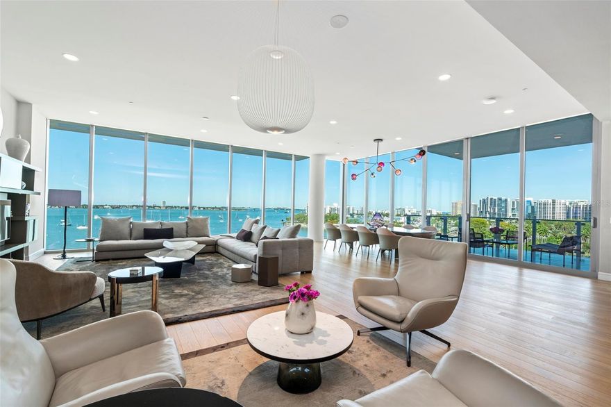 Experience the epitome of ultra-luxury living at EPOCH, one of the most coveted waterfront condominiums on the West Coast of Florida. Behold Residence #6, a dazzling masterpiece of architecture and design offering stunning panoramas of the downtown city skyline, Sarasota Bay, and the Gulf of Mexico. Spanning an impressive 4333 air-conditioned square feet, this Coastal contemporary residence boasts magnificent owners’ quarters and three luxurious en-suite guest suites, seamlessly blending exceptional comfort, cutting-edge technology, and chic design elements to create an unequivocally lavish lifestyle. Beyond its impressive interior appointments, floor-to-ceiling impact glass walls and three enormous private terraces provide 360-degree views, showcasing the modern elegance of this near newly construction building. Accessible via private elevator, the foyer welcomes you with Deguorney silk wallcovering, leading into the residence where sky-high views unfold through a full wall of floor-to-ceiling impact rated glass, seamlessly connecting indoor and outdoor spaces. Soaring 12’ ceilings and an open floor plan enhance the grand scale of the central living spaces, with distinctive zones arranged to preserve a sense of intimacy. The great room features  an incredible custom built-in wall system with clean lines and display shelving which sets the stage for large-scale entertaining. The open dining area offers direct access to the terrace with a smart summer kitchen, perfect for gatherings. The gourmet kitchen features bespoke Italian soft-close cabinetry, expansive storage, quartz countertops, and top-of-the-line Gaggenau appliances, including a six-burner gas range, double wall ovens, side-by-side refrigerator and freezer, and wine refrigerator. The owners’ suite, boasting spectacular marina and sunset views, serves as a luxury retreat beyond compare. The expansive bedroom includes a seating area and direct access to the bayfront terrace with additional Bay side lounge space. The walk-in closet, perfectly customized, sits adjacent to the oversized bathroom with a huge walk-in shower, a sculptural tub, double vanities with seating, and 2 water closets. The three additional en-suite bedrooms each feature generous customized closets and abundant natural lighting. Premium technological integrations include Lutron automated shades, Smart lighting control, and multi-zone air conditioning. Spacious home laundry facilities, an adjacent gigantic storage room, and parking for 2 cars further enhance the conveniences. EPOCH was meticulously conceived to offer the highest level of luxury living, celebrating the renowned mid-century modern style of the Sarasota School of Architecture. Residents of the 23 exclusive residences enjoy world-class amenities, personalized services, and enhanced security. Nestled on the shoreline of Sarasota Bay and just steps from the city’s cosmopolitan core, EPOCH seamlessly blends contemporary elegance with unrivaled quality for the pinnacle of luxury living on the Gulf Coast.