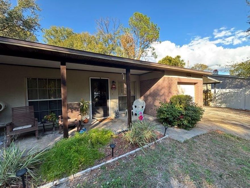 This charming 3 bedroom, 2 bath home offers over 1,400 square feet of living space and sits on almost half acre lot in sought after Town ’n’ Country area. Featuring attractive brick curb appeal, an attached one car garage, and an additional one car carport. Inside, you’ll find a well-maintained interior with vintage character and retro charm, offering a solid foundation for buyers looking to personalize or update at their own pace. The spacious layout provides comfortable living areas, generous bedrooms, and great natural light throughout. Situated on a high and dry lot with no history of flooding, offering peace of mind along with room to expand, garden, or simply enjoy the oversized yard. Ideally located just minutes from Tampa International Airport, Downtown Tampa, Westchase, and world-renowned Clearwater Beach, this home combines space, character, and convenience in one of Tampa’s most accessible areas. Don't miss your opportunity to make this one yours!